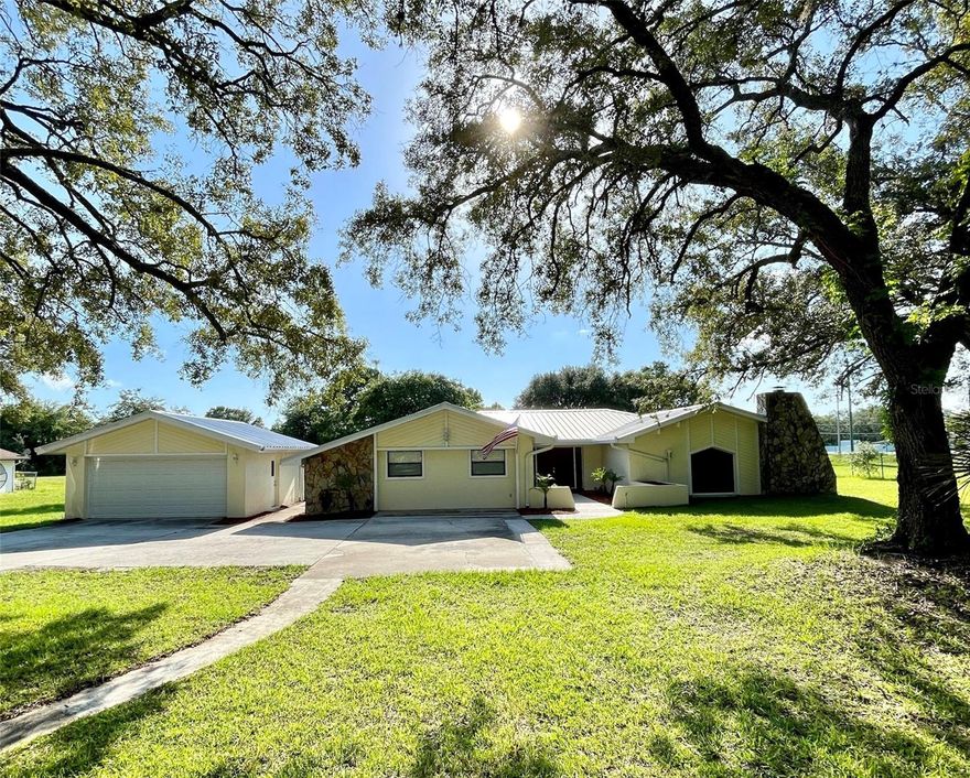 One or more photo(s) has been virtually staged. BUYER INCENTIVE + PRICE IMPROVED for this magnificent ranch, nestled among the mature oak trees on a sprawling 1.5-acre lot, presenting a tranquil, picturesque setting in Rolling Oaks Estates of Hudson. With 3,190 square feet of living space & open floor-plan layout, this home is perfect for comfortable living & entertaining. This residence boasts four huge bedrooms, each with its own en-suite bathroom, providing privacy & convenience for everyone. One of the bedrooms features its own private entrance, making it ideal for an in-home office, a recreation room, or even a mother-in-law suite. The primary suite is a retreat within itself, offering ample space & a refreshed en-suite bathroom, complete with a dual vanity & walk-in shower. French doors lead you outdoors, onto a backyard patio where you can enjoy the sights & sounds of nature. This kitchen is a chef's dream of functionality and style. Prepare culinary delights in the modern & updated kitchen, complete with granite countertops, soft-close cabinets, stainless steel appliances, a stylish backsplash, and a massive island with bar seating & additional cabinets for storage. There's also a pass-through window from the kitchen to the lanai for convenience. Enjoy the cozy ambiance of the spacious living room area which has gorgeous ceiling beams, a wood-burning stone fireplace, & a wet bar area. It’s wonderful for entertaining guests or simply unwinding after a long day. Additional features of this remarkable home include tile flooring throughout, a convenient indoor laundry room with a utility sink & storage cabinets, and a screened-in patio where you can enjoy breathtaking sunsets or relax in the 5-seater hot tub, which has various jets & a raised waterfall with lighting feature. Take a dip to cool off during those hot summer days in the refreshing 28' round above-ground swimming pool. For car enthusiasts or those needing extra storage space, there's a detached 2-car garage, a long driveway, PLUS an extended concrete pad for additional vehicle parking. With NO REAR NEIGHBORS, you'll have the utmost privacy. This 1.5 acre lot could be utilized for gardening, livestock or indulging in outdoor activities. NO HOA & NO CDD. Schedule your showing today!
ATTN BUYERS: SELLERS ARE WILLING TO CONTRIBUTE $5,000 TOWARDS BUYER'S CLOSING COSTS OR INTEREST RATE BUY-DOWN!!