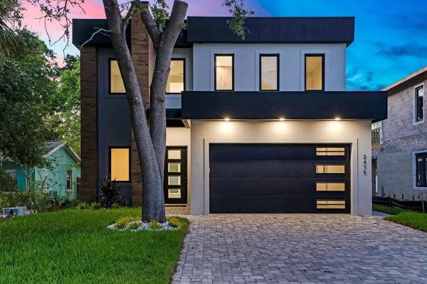 Experience refined modern living at 2475 Bay Street, a brand-new contemporary residence offering 2,874 square feet of thoughtfully designed space. Clean architectural lines and a striking façade set the tone, while inside, sun-filled interiors reveal soaring ceilings, expansive open-concept living areas, and walls of glass that create a seamless indoor-outdoor connection. The home is designed to feel both elevated and livable, with spaces that flow naturally for entertaining, relaxing, and everyday life.
The home features four bedrooms and four bathrooms, including a main-level primary suite that offers split-plan privacy and direct access to the pool area. The primary bath includes a double vanity, walk-in shower, soaking tub, and spacious his-and-hers closets with built-in accessories. The chef’s kitchen is outfitted with Café appliances accented in gold, premium cabinetry, Calcutta quartz countertops throughout the home, and a dramatic waterfall island seating eight. An upstairs living area overlooks the main level and opens to a second-story balcony, while additional bedrooms feature en-suite baths for comfort and privacy. Additional highlights include a custom resort-style pool, fully fenced yard, covered lanai with a fully equipped outdoor kitchen, two-car garage, energy-efficient construction, paver driveway accommodating up to four vehicles, and a mudroom with direct access to the pantry.
Ideally located in central Sarasota, this home offers a peaceful residential setting with quick access to downtown and the area’s top attractions. Enjoy nearby Main Street dining, boutique shopping, and cultural venues such as the Sarasota Opera House, Florida Studio Theatre, and McCurdy’s Comedy Theatre. Outdoor and lifestyle destinations include Bayfront Park and Marina, Marie Selby Botanical Gardens, Payne Park, St. Armands Circle, Sarasota Jungle Gardens, The John and Mable Ringling Museum of Art, and Mote Marine Aquarium. World-renowned beaches including Siesta Key, Lido Key, and Longboat Key are just minutes away, along with convenient access to Publix, Sarasota Memorial Hospital, top schools, and Sarasota-Bradenton International Airport.
Schedule your private tour and experience the design, flow, and lifestyle of this unique Sarasota property before it slips away.