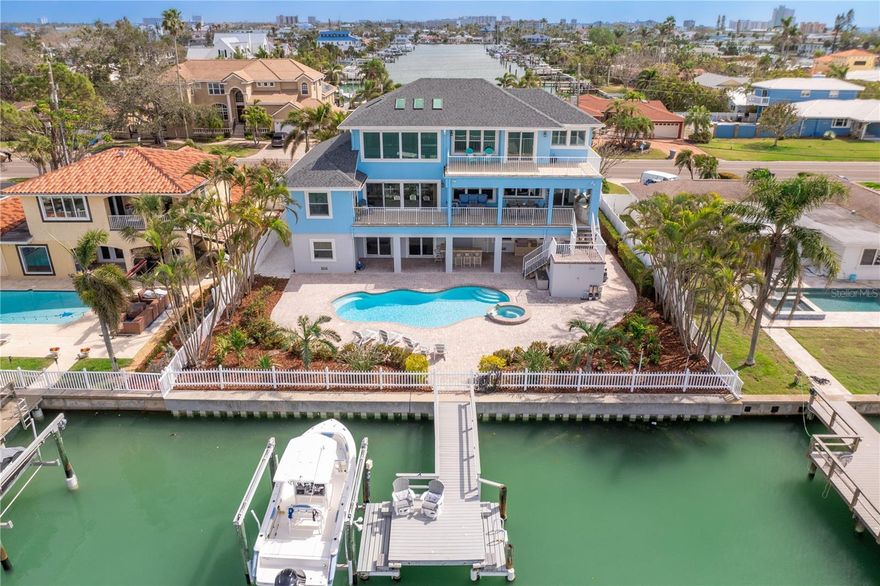 Live the Waterfront Dream on Treasure Island.  Welcome to your own slice of paradise—this exceptional waterfront residence is perfectly positioned on a wide, deep canal with coveted “head of the table” placement, offering both privacy and panoramic water views. Thoughtfully designed and meticulously maintained, this home delivers the ultimate coastal lifestyle with spacious interiors, expansive outdoor living areas, and premier boating access just minutes to the Gulf of Mexico.

Step inside to discover a bright and inviting open floor plan that maximizes natural light and water views. The chef’s kitchen is a true showpiece, ideal for entertaining, and flows seamlessly into generous living and dining spaces. The main level features three spacious bedrooms with ensuite access. The private 800 sq ft primary suite encompasses the entire upper floor and includes a inspired ensuite, a spacious walk-in closet including separate laundry closet, a private deck overlooking the waterfront and is also accessible via a 3 stop elevator...all are just a few of the attributes you will love about this home!   

Enjoy over 1,300 sq ft of covered outdoor living, a heated pool and spa, newer seawall, and a fully equipped dock with 10,000 lb lift, water and electric hook-up—perfect for the boating or fishing enthusiast. With 774 sq ft of garage and more than 1,000 sq ft of climate-controlled flex space, there’s ample room for cars, bikes, gym equipment, and all your coastal toys.  

Located just a short stroll or bike ride to Treasure Island’s white sandy beaches, vibrant dining, and boutique shopping. Easy access to downtown St. Petersburg’s cultural scene to enjoy trendy restaurants, award winning museums, major league sports, and two international airports makes this the ideal full-time residence or luxury retreat. Flood insurance is just $841/year.