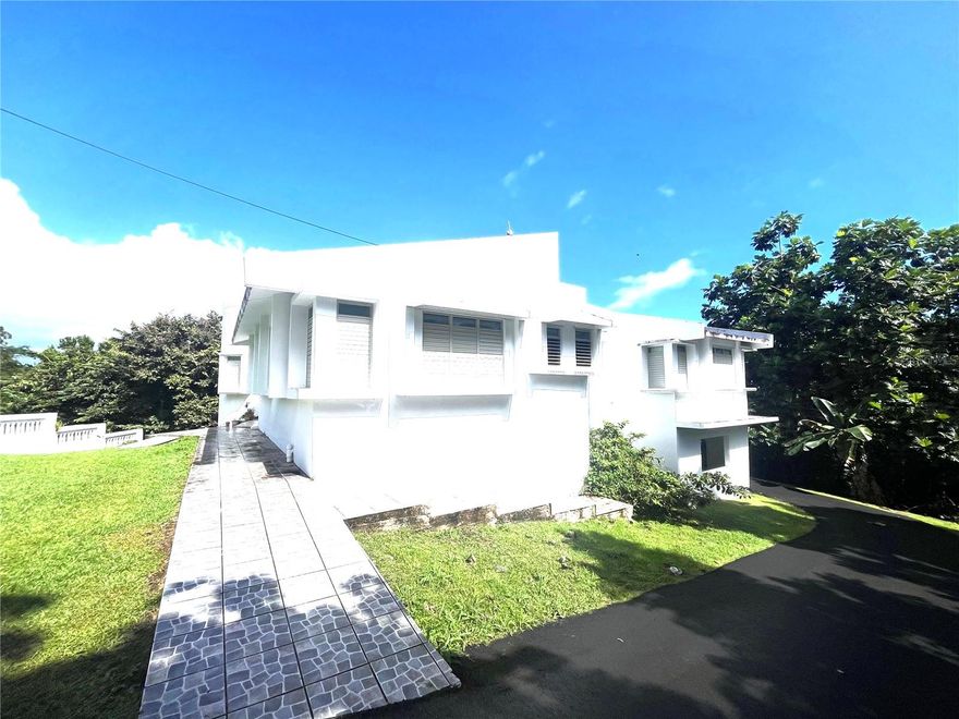 New Price. Solid construction estate with almost two-acre lot in a two-story residence with the advantage of main floor living.  Offering the privacy and serenity this lushly landscaped oasis provides to the discerning buyer.  Three large bedrooms and two full and a half bathroom with large open spaces throughout, open floor plan and a concrete large porch off the kitchen with scenic mountain vistas and mature fruit trees.  Gated compound providing parking for over 8 automobiles.  Practical design offering suitable spaces for expansion.  The residence is in close proximity to San Antonio Abad school and the University of Puerto Rico Humacao Campus.  Convenient to retail, restaurants, grocery shopping and easy access to major roads and highways, No HOA fees.  Call to schedule your private showing to appreciate space, privacy and superb views.  Nature at its best with excellent location for everyday living.