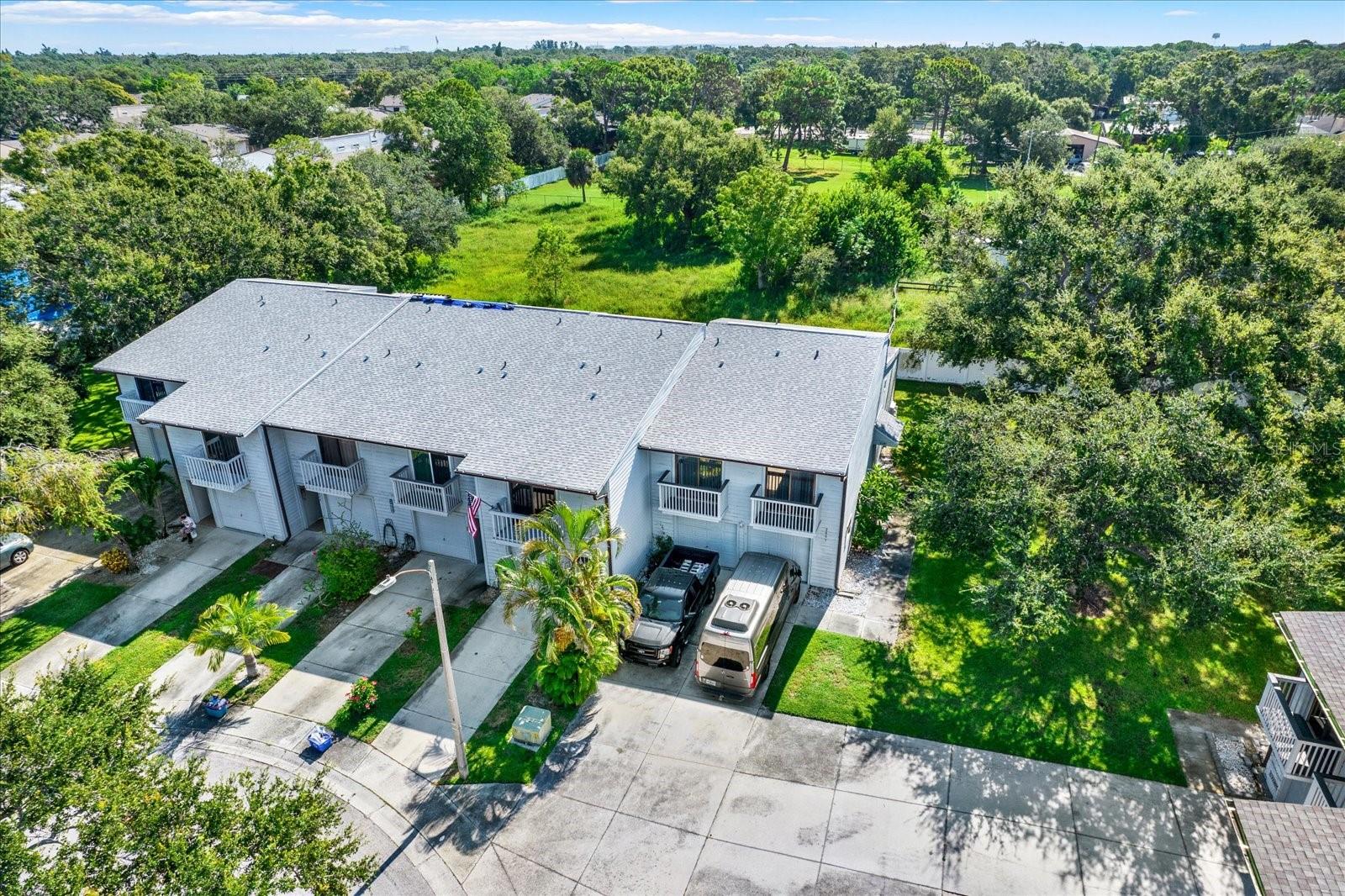 END UNIT- Well appointed 3BR/2BA tri-level condo with oversized 2-car garage, located on a quiet cul-de-sac in the heart of Pinellas County’s equestrian area. This home features vaulted ceilings, skylights, and luxury vinyl plank flooring throughout. Updated kitchen with granite counters, white cabinetry, and large island, spacious and open great for entertaining. The spacious primary suite includes a walk-in closet and updated en-suite bath with dual sinks and walk-in shower. Two guest bedrooms each have private balconies. Enjoy tranquil views of a horse farm from your private screened enclosed back patio. New HVAC to ensure cool comfort year round! HOA includes roof, exterior, internet, cable, water, trash, pool, and more. Pet-friendly community allows for Large Dogs and dog walk area is just steps away from your front door. Relax and enjoy the tranquil heated (when needed) pool/spa, pond, boardwalk, and access to 60-acre Helen Howarth Park with trails. Convenient to schools, shopping, beaches, and downtown St. Pete.