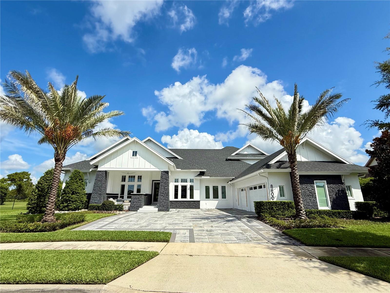 Experience Luxury Living at Its Finest.
This warm, contemporary residence blends modern-transitional style with the highest level of finishes throughout. Offering approximately 5,718 sq. ft. of living space and nearly 7,594 sq. ft. under roof, every detail of this home is crafted to deliver elegance, functionality, and lifestyle excellence.
Featuring five spacious ensuite bedrooms plus an additional full bathroom, the layout is both versatile and inviting. On the main level, you'll find four bedrooms, including the luxurious primary suite a serene retreat with two oversized walk-in closets and a spa style bathroom adorned with exquisite finishes. Additional main-level spaces include formal living and dining rooms, an open-concept kitchen-family room-eating area, a Florida room, a spacious laundry room, a dedicated home office, and a three-car garage with ample storage. Upstairs offers one more bedroom and a versatile multi-purpose room, all set on a .71-acre lot.
At the heart of the home, the gourmet kitchen showcases frameless contemporary cabinetry with automatic lighting, a generous center prep island, three built-in pantry cabinets and premium Wolf and Sub-Zero appliances. The kitchen flows seamlessly into the spacious great room and Florida room, creating the perfect indoor-outdoor living experience.
Step outside to your private outdoor oasis, where beautifully landscaped grounds frame serene conservation views. Enjoy a sparkling pool, relaxing spa, summer kitchen with Bull premium appliances, tranquil yard, expansive covered living space, a fireplace and a basketball court. With plenty of outdoor seating areas, this space is designed for year-round entertaining.
This exceptional home combines sophisticated design, luxurious finishes and an unbeatable layout perfect for both everyday living and memorable gatherings.