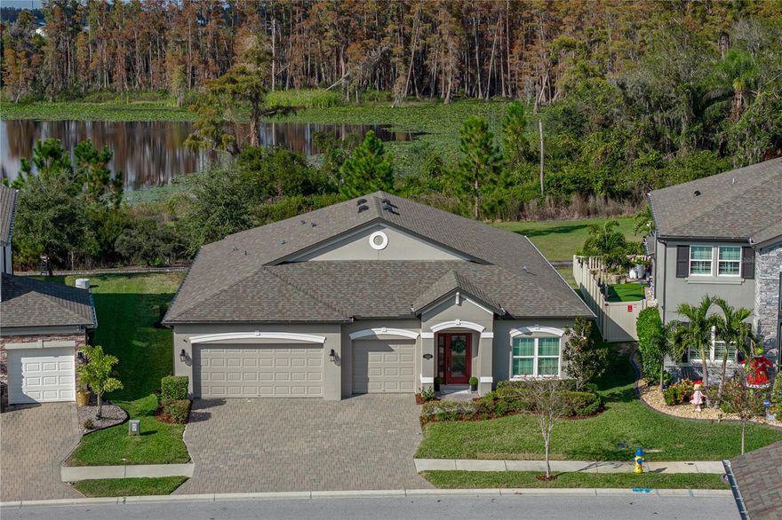 **DISCOVER A TRULY EXCEPTIONAL, PRIVATE, AND RARELY AVAILABLE LOT WITH LAKE AND CONSERVATION VIEWS IN THE HEART OF LUTZ** One of the most pristine, coveted home sites in the community! **2019 M/I HOME** The popular Corina II "B" floorplan. This single-story residence sits on a breathtaking, ultra-private setting backing directly to Camp Lake with peaceful conservation beyond, offering unobstructed views and a level of serenity that’s nearly impossible to find. **LOW HOA** **NOT IN A FLOOD ZONE** Featuring 4 beds, 3 *full* baths, and a **3 CAR GARAGE** Pride of ownership and curb appeal greet you with a paver driveway, fresh mulch, neatly trimmed landscaping, and a freshly painted neutral exterior color scheme sure to impress! Step inside to an open, light-filled layout featuring 9'4" ceilings, laminate flooring, crown molding, an abundance of lighting, and an expansive main living area framed by two large sliding glass doors that showcase the stunning natural backdrop. The beautifully appointed kitchen includes stainless steel appliances, 42" upper cabinets with crown molding, glass tile backsplash, double oven range, undermount sink, center island with bar seating overlooking the living space and lake view, pantry, lazy Susan, and pull-outs in all lower cabinets. The spacious primary suite at the very back of the home offers incredible privacy, comfort and lake views! Complete with a massive walk-in closet and a well-designed bathroom featuring a soaking tub, separate shower, dual vanities, and private water closet. Three additional bedrooms and two full guest baths provide flexibility for family, guests, or a home office. Enjoy outdoor living on the **47-FOOT WIDE** covered lanai, offering generous shade and room to expand with a future pool and screen enclosure—made even more impressive by the unmatched view. The 3-car garage includes durable epoxy flooring. **BRAND NEW EXTERIOR PAINT** was completed in November 2025, and the interior has been professionally touched up for a crisp, move-in-ready finish. **ENJOY UPGRADES TO INCLUDE rain gutters, connection on the lanai for a spa that could also power a generator, hurricane covers for all windows and doors, 8 foot interior doors, a utility sink in the garage, and upgraded light fixtures.** Zoned for highly rated schools! Located just minutes from the Tampa Premium Outlets, a mile from SR-54’s extensive shopping and dining, approximately 5-10 minutes to the Veterans Expressway, within a 30-minute drive to Tampa International Airport and Downtown Tampa, and within an hour to beautiful beaches like Clearwater Beach and Honeymoon Island! The community features a nature path behind the home, swimming pool, playground, tennis court, and basketball court. This is an extraordinary opportunity to own a home on one of the best and most private lots in Lutz—a rare find you won’t want to miss.