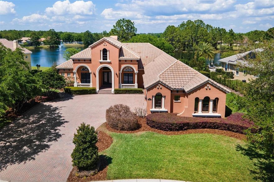 DISCOVER WATERFRONT LUXURY in the highly sought-after gated community of Loch Leven! This STUNNING POOL HOME  offers 3 bedrooms, 2.5 baths, and an OVERSIZED 3 CAR GARAGE—perfectly designed for both everyday living and entertaining. Step through the grand entrance into a beautiful living room featuring a striking stone fireplace and breathtaking views of the pool and waterfront. The spacious family room flows seamlessly into the gourmet kitchen and dining area, complete with updated stainless steel appliances, a granite center island, and a breakfast bar. Wine lovers will appreciate the elegant iron door wine cellar, complete with a wine fridge and additional cabinetry. The luxurious primary suite is a true retreat, featuring its own wet bar, wine fridge, and French doors that open directly to the pool and lanai. The spa-like primary bath includes dual vanities, a jetted garden tub, a walk-in shower, and an expansive walk-in closet. DOUBLE TRAYED SOARING HIGH CEILINGS, CROWN MOLDING, PLANTATION SHUTTERS,  AND DETAILED UPGRADES THROUGHOUT. Step outside to your private oasis—an impressive pool overlooking the water, surrounded by custom pavers and a built-in firepit, perfect for relaxing evenings and entertaining guests. Additional highlights include a paver driveway, oversized 3-car garage with extra storage, and an inside laundry room with built-in cabinets and a utility sink. POOL WITH SALT FILTER 2022, HW HEATER 2020, AND HVAC 2021.  Residents of Loch Leven enjoy exceptional amenities including a picnic area, playground, tennis courts, basketball court,  fishing dock, and private boat ramp. Ideally located just minutes from downtown Mount Dora’s charming shops, dining, and entertainment, with convenient access to Florida's turnpike and major highways. Experience the perfect blend of elegance and Florida waterfront living-this is the dream home you have been waiting for.