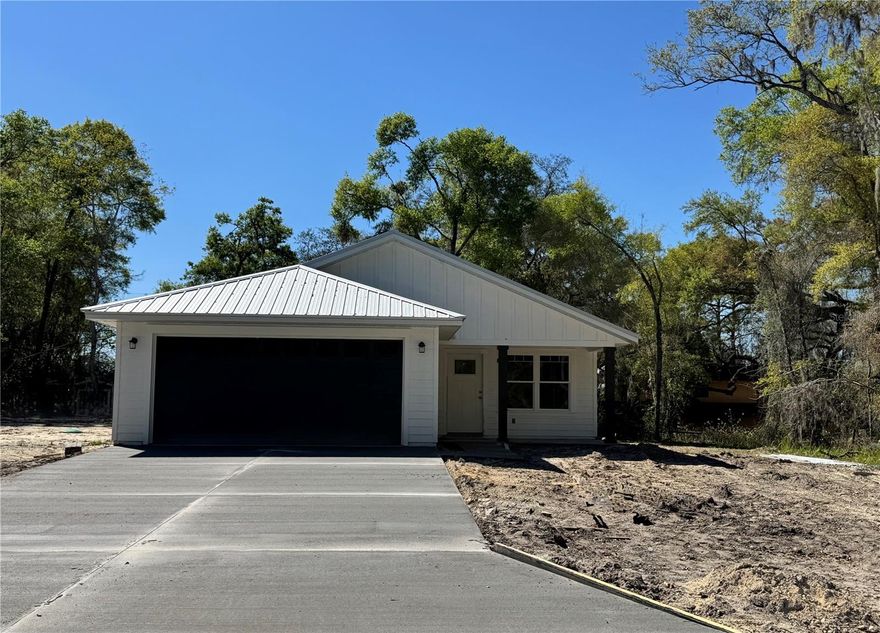 Under Construction. One or more photo(s) has been virtually staged. Under Construction. One or more photo(s) has been virtually staged. Pictures are of a prior completed model. Estimated completion date Feb 2026. This bright & open floor plan sits on a spacious .23 acre lot located 5 minutes from downtown Newberry with the benefit of the low Gilchrist County taxes. The home features step up tray ceilings in the great room & primary suite, a spacious kitchen island, energy efficient appliances & raised panel custom wood cabinets. Doors off of the kitchen lead to a covered patio - perfect for entertaining and indoor/outdoor living. The luxury master suite boasts an inviting bathroom w/double vanities, European style shower & oversized walk-in closet. There is no shortage of storage in this home including a spacious laundry room for all of your organizational needs! Home features 2-car garage and metal roof. The layout of the virtually staged photos may not necessarily match the layout of this lot - please visit site to see lot and home details.