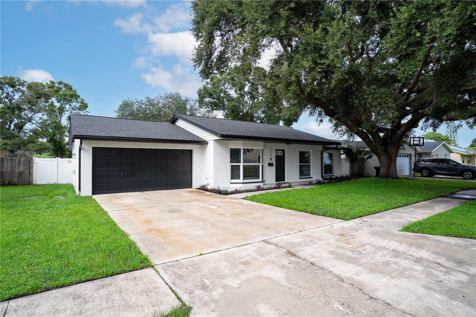 Welcome to this beautifully renovated 4-bedroom, 3-bath single-family home in St. Petersburg, featuring a spacious 2-car garage and a fully fenced backyard. Every detail has been updated, including a 2022 HVAC system, brand new roof, hurricane impact windows, gas tankless water heater, all new lighting, ceiling fans, interior doors, and fresh landscaping. The open floor plan highlights an oversized living room with double bay windows and a brand-new kitchen complete with white shaker cabinets, quartz countertops, a large island, and stainless steel appliances. Two primary suites with en-suite bathrooms offer comfort and flexibility, while the additional bedrooms share a stylishly updated guest bath. Durable LVP flooring flows throughout the home, creating a seamless modern look. Located in a non-flood zone just minutes from downtown St. Pete, Gulf beaches, shopping, dining, and entertainment. Don’t miss the chance to make this move-in ready home yours—schedule your private showing today!