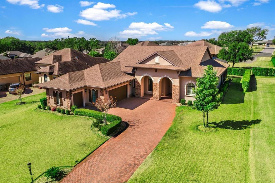 AWESOME POOL HOME...ASSUMBALE 4.25% MORTGAGE with approx. balance of $608,000! Elegant, upgraded residence located in an exclusive gated, Golf community with 24/7 guard service. This refined home offers a desirable open-concept, split-bedroom floor plan with engineered wood flooring, crown molding, and soaring ceilings throughout. The great room features a dramatic floor-to-ceiling stacked stone gas fireplace and expansive tinted sliders with transom windows for abundant natural light. The gourmet kitchen is showcasing granite countertops and backsplash, a large snack bar for additional seating, premium stainless-steel appliances including a Bosch induction cooktop, built-in oven and microwave, LG dishwasher, and a double-door refrigerator with craft ice maker, plus a spacious walk-in pantry!
The private primary suite with a "spa like" bath is thoughtfully separated from the guest wing, which includes two bedrooms, a bonus room/den, a Jack-and-Jill bath with oversized walk-in shower, and an additional full bath. Sliding glass doors from the dining area and great room open to a screened lanai with a custom pool with waterfall, complemented by a covered outdoor living area with gas for a grill and/or fire pit—ideal for entertaining. Additional highlights include a laundry room with sink and cabinetry, oversized two-car garage with golf cart parking and storage, whole-house filtration system, and beautifully landscaped grounds with paver driveway and stone archway entry. Exceptional opportunity for luxury living with privacy, security, and lifestyle ... Enjoy the clubhouse, tennis, pickle ball, heated "Olympic size pool", fitness room, activities and more. Golf Membership available for separate fees... Year around "RESORT STYLE LIVING" AWAITS!!