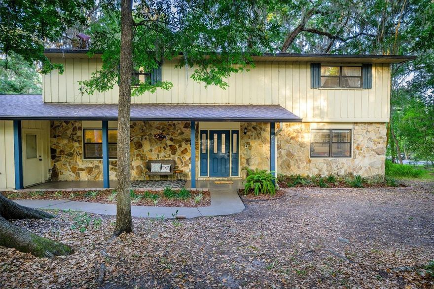 Experience the warmth and serenity of country living, conveniently located within reach of modern amenities. Embraced by shady canopies of mature trees, this home is surrounded by timeless, natural beauty. 

Whether you want to enjoy the birds from the swing, sip your morning coffee in the beautifully appointed Florida Room, or perfect your tennis skills on your private tennis court, this home is tailored for the Florida lifestyle.

Inside, the home has hardwood floors, wood cabinets and stone countertops. There is ample square footage in this flexible, functional layout. Downstairs, there is a family room, as well as a large flex room that can be used for entertaining, gaming, or as a den. The downstairs also offers a bedroom, as well as an additional bonus room that would make an excellent 5th bedroom or office.

Upstairs, there are 3 more bedrooms, and two bathrooms. 

This charming home is ready to bring your vision of country living to fruition, without the headache of a CDD or HOA. The freedom of an AR2 zoning allows flexibility and freedom.