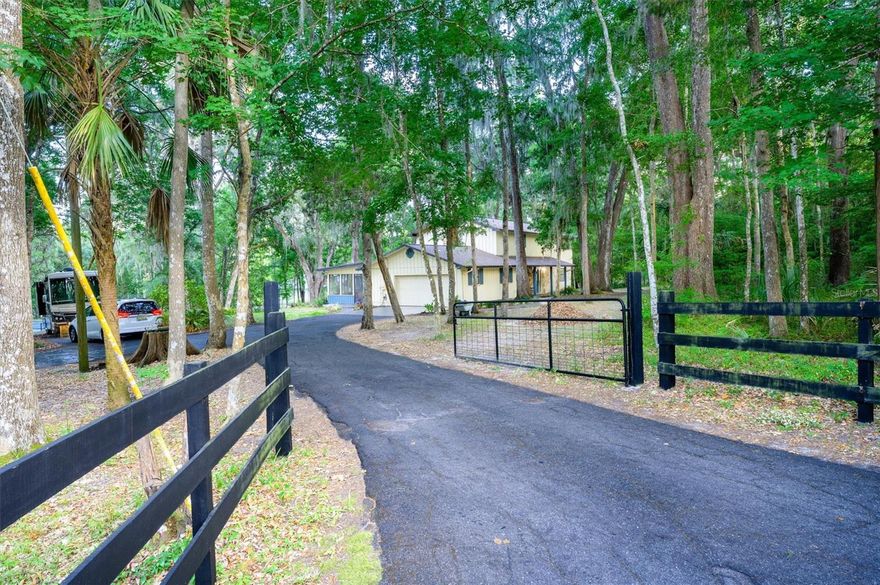 Experience the warmth and serenity of country living, conveniently located within reach of modern amenities. Embraced by shady canopies of mature trees, this home is surrounded by timeless, natural beauty. 

Whether you want to enjoy the birds from the swing, sip your morning coffee in the beautifully appointed Florida Room, or perfect your tennis skills on your private tennis court, this home is tailored for the Florida lifestyle.

Inside, the home has hardwood floors, wood cabinets and stone countertops. The kitchen features updated appliances, alongside a brand new dishwasher. There is ample square footage in this flexible, functional layout. Downstairs, there is a family room, as well as a large flex room that can be used for entertaining, gaming, or as a den. The downstairs also offers a bedroom, as well as an additional bonus room that would make an excellent 5th bedroom or office.

Upstairs, there are 3 more bedrooms, an office, and two updated bathrooms. The master has a walk-in closet, a roomy en-suite bathroom, and vaulted ceilings. The roof has plenty of life left, installed in 2021. The AC is brand new (2025) and ready to handle the Florida heat! 

This charming home is ready to bring your vision of country living to fruition, without the headache of a CDD or HOA. The freedom of an AR2 zoning allows flexibility and freedom.