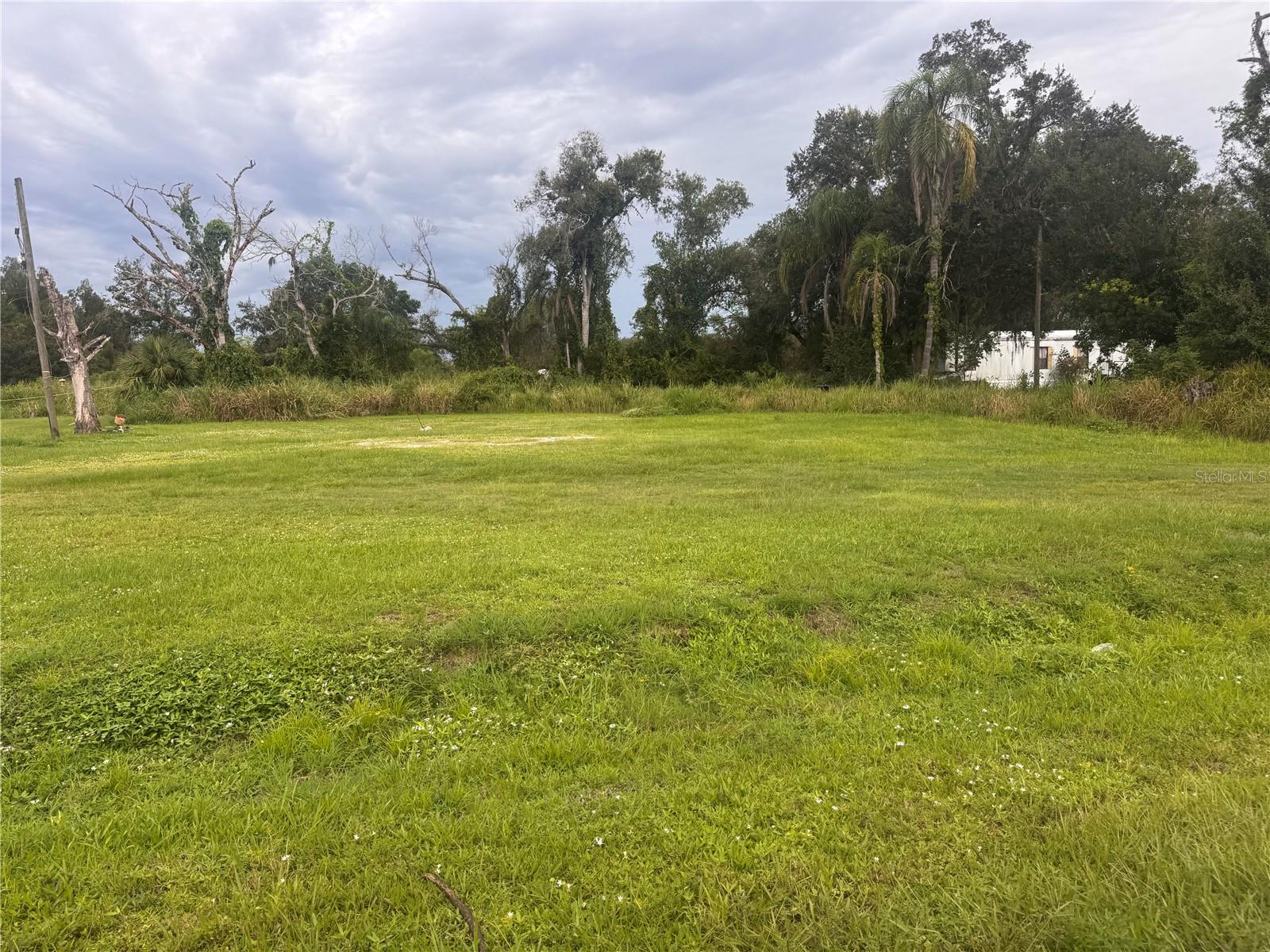 Cleared half-acre lot ready for residential construction. Property includes a well, power pole, and culvert. A septic system may be present from a previous mobile home. offering convenience and privacy. Suitable for a single-family home on a dead-end paved street makes it attractive for a new home. Awesome lot.. Take look at this today