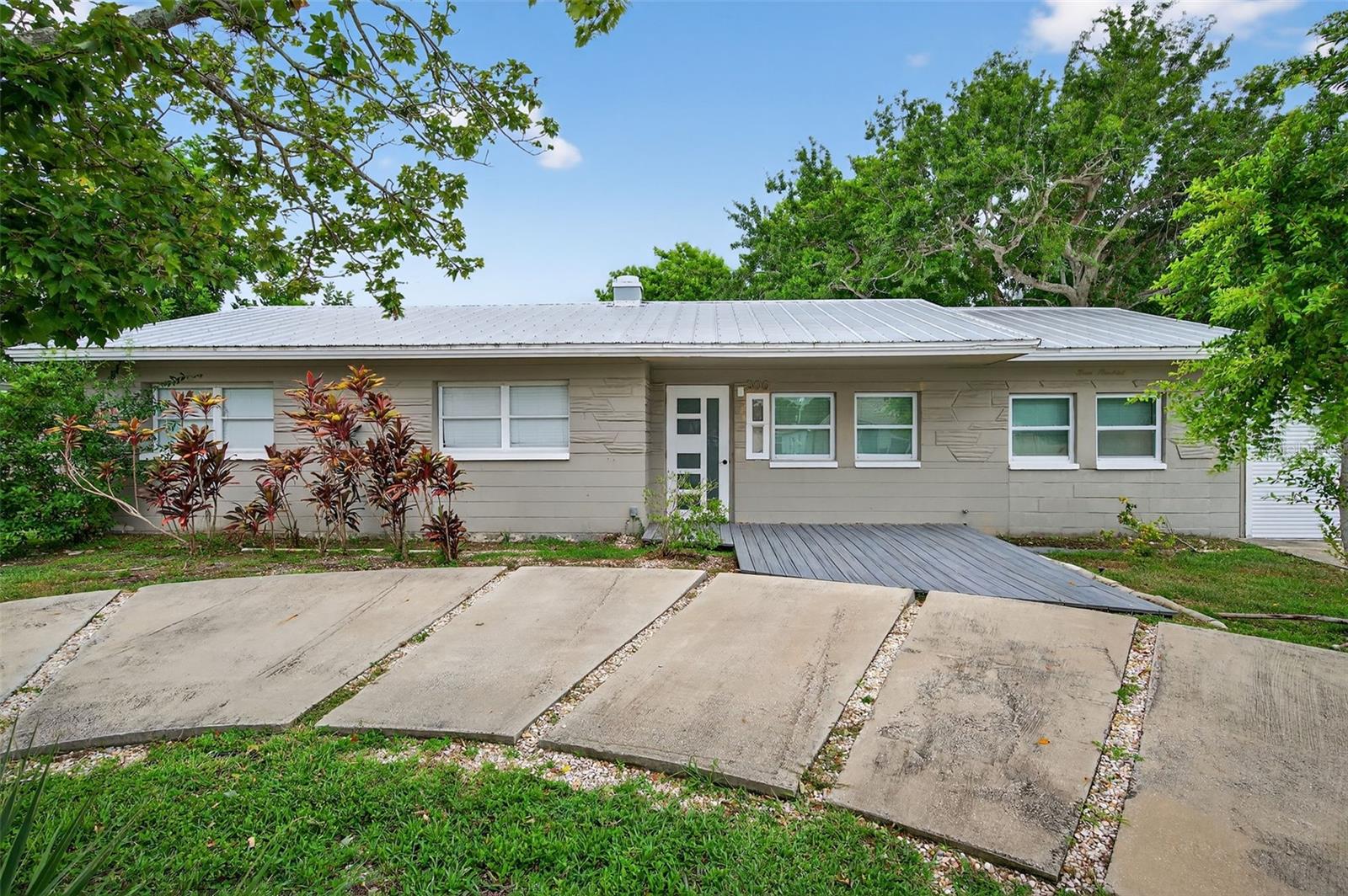 Perfectly positioned in the peaceful Edgemoor Estates neighborhood, this beautiful St. Pete ranch blends charm, comfort, and convenience. A half-circle driveway offers plenty of parking and leads you inside to a unique open floor plan with warm wood and tile flooring throughout. The bright kitchen is ideal for entertaining featuring stainless steel appliances, a center island for extra prep space, concrete countertops, and a wine fridge. Just off the main living area, a sun-filled Florida room with multiple sliding glass doors offers the perfect spot to relax or host gatherings.
The home offers three spacious bedrooms, including a private primary suite with a large walk-in shower. The second bath features a soaking tub for the ultimate retreat. Step outside to a fully fenced backyard with a deck for al fresco dining and plenty of room to enjoy Florida’s year-round sunshine. Additional highlights include an inside laundry room and a one-car garage.
Just minutes from downtown St. Pete, you’ll have easy access to waterfront parks, golf courses, shopping, dining, breweries, and events. Quick drives take you to Tropicana Field, two major airports, and beaches less than 15 miles away. This move-in ready home is the perfect blend of city convenience and neighborhood tranquility. Don’t miss your chance to make it yours!
