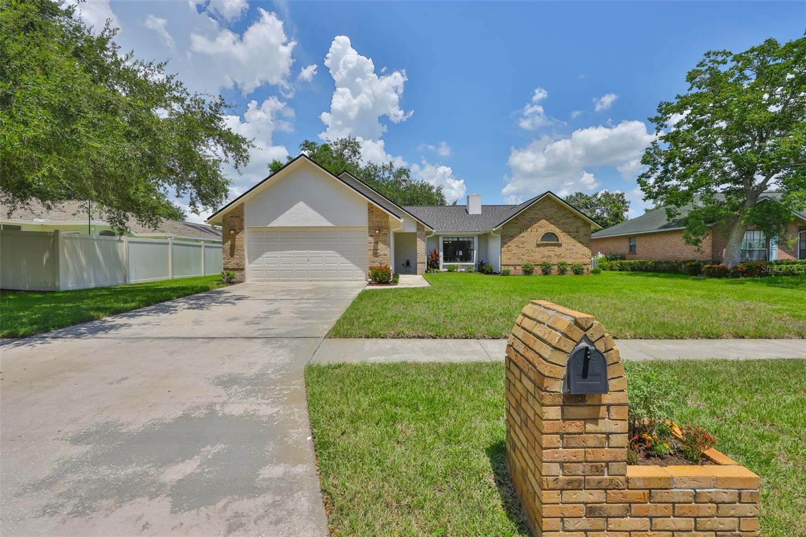 Tired of cookie-cutter houses? This original-owner gem breaks the mold with custom touches, solid construction and standout style. Situated on a lush 75-foot-wide lot, this bright home features vaulted ceilings, real wood flooring, a bay window and a classic wood-burning fireplace! The kitchen is a true standout, showcasing the timeless design trend of exposed brick accents, a tray ceiling with wood inlay, Kraftmaid white wood cabinetry with dovetail drawers and soft-close hinges, granite countertops with a breakfast bar, double ovens + a cooktop and a range hood that vents to the outdoors. Modern updates include two sets of French doors with internal blinds, neutral two-tone paint throughout and no carpet anywhere in the home! The primary bathroom has been completely renovated and includes white quartz slab countertops, dual undermount sinks, large 24"x12" tile flooring, a frameless glass shower with floor-to-ceiling luxury tile and Kraftmaid cabinetry with pull-out shelving. Step outside to enjoy nearly 400 square feet of screened and covered lanai space overlooking a peaceful pond and mature Florida landscaping--ideal for relaxing, bird watching or entertaining. Key updates include a new roof in 2022, HVAC in 2023 and gutters. A clean 4-point inspection report is available, and while flood insurance is required, the current policy is just $535 per year! This block home has had no history of hurricane, flood or water damage. Located in Riverview's Ashley Oaks community, residents enjoy access to a community clubhouse & pool--a great perk for year-round Florida living. The HOA fee is only $650 per year and there is no CDD! Ideally located less than two miles from both I-75 and the Selmon Expressway, this home offers quick access to downtown Tampa and MacDill AFB. Enjoy easy access to local shopping and dining options on US 301, Bloomingdale Ave, Lumsden Rd and Brandon Blvd. Zoned for Riverview Elementary (less than 1 mile away), Giunta Middle School (under 3 miles) and Spoto High School (under 2 miles), this location also puts you just a mile from Riverview Park and Recreation Center with public tennis courts. Don't miss this rare opportunity to own a character-filled, move-in-ready home in a highly convenient and desirable location! Check out the ZILLOW tour and floor plan with room measurements & ask for a copy of the 4-Pt report!