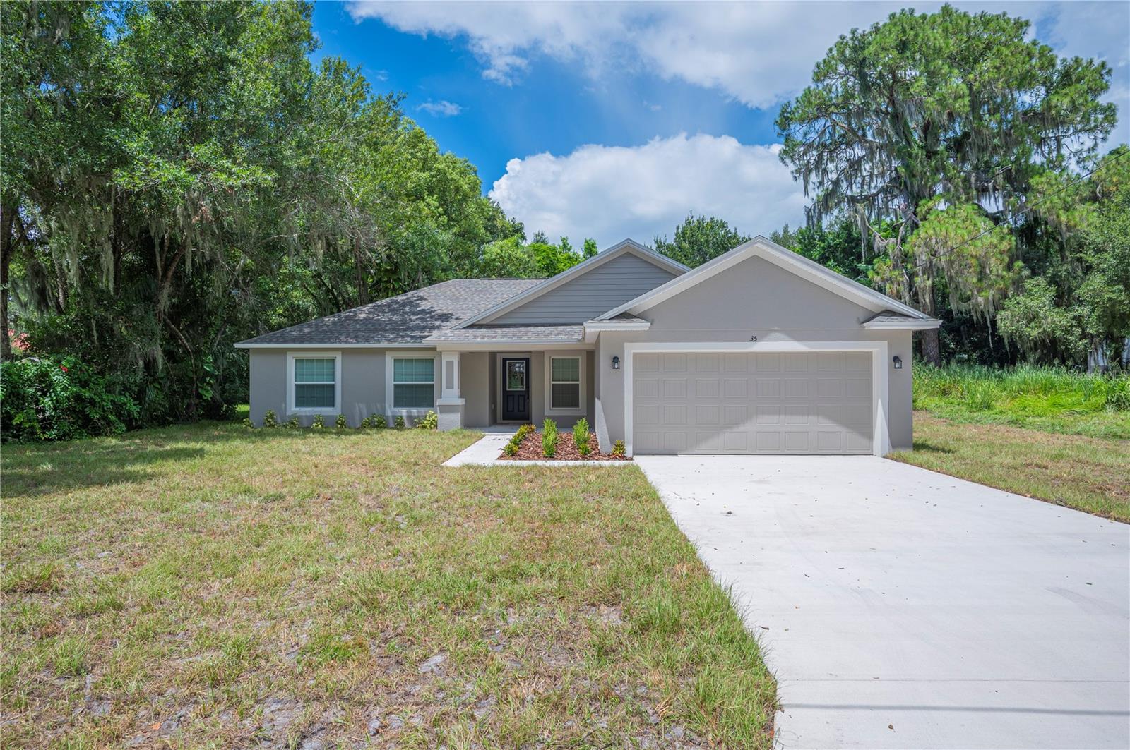 Welcome to this beautiful 4-bedroom, 2-bathroom new construction Savannah model by Southern Homes in Frostproof, FL. This home features an open floorplan perfect for both everyday living and entertaining. The kitchen is equipped with 42-inch cabinets, quartz countertops, stainless steel range, dishwasher, microwave, and refrigerator, along with a spacious eat-in nook. The master suite offers a tiled walk-in shower and double vanity, while the second bathroom features a relaxing tub. Tile flooring runs throughout all common areas, with cozy carpet in the bedrooms. Enjoy outdoor living with both front and back covered porches. The 2-car garage includes a garage door opener for convenience. Best of all, NO HOA gives you the freedom to truly make this property your own. This home also comes with a 2-10 Home Buyers Warranty, providing peace of mind. Don’t miss the opportunity to own this brand new home in a charming Frostproof community — schedule your private tour today!