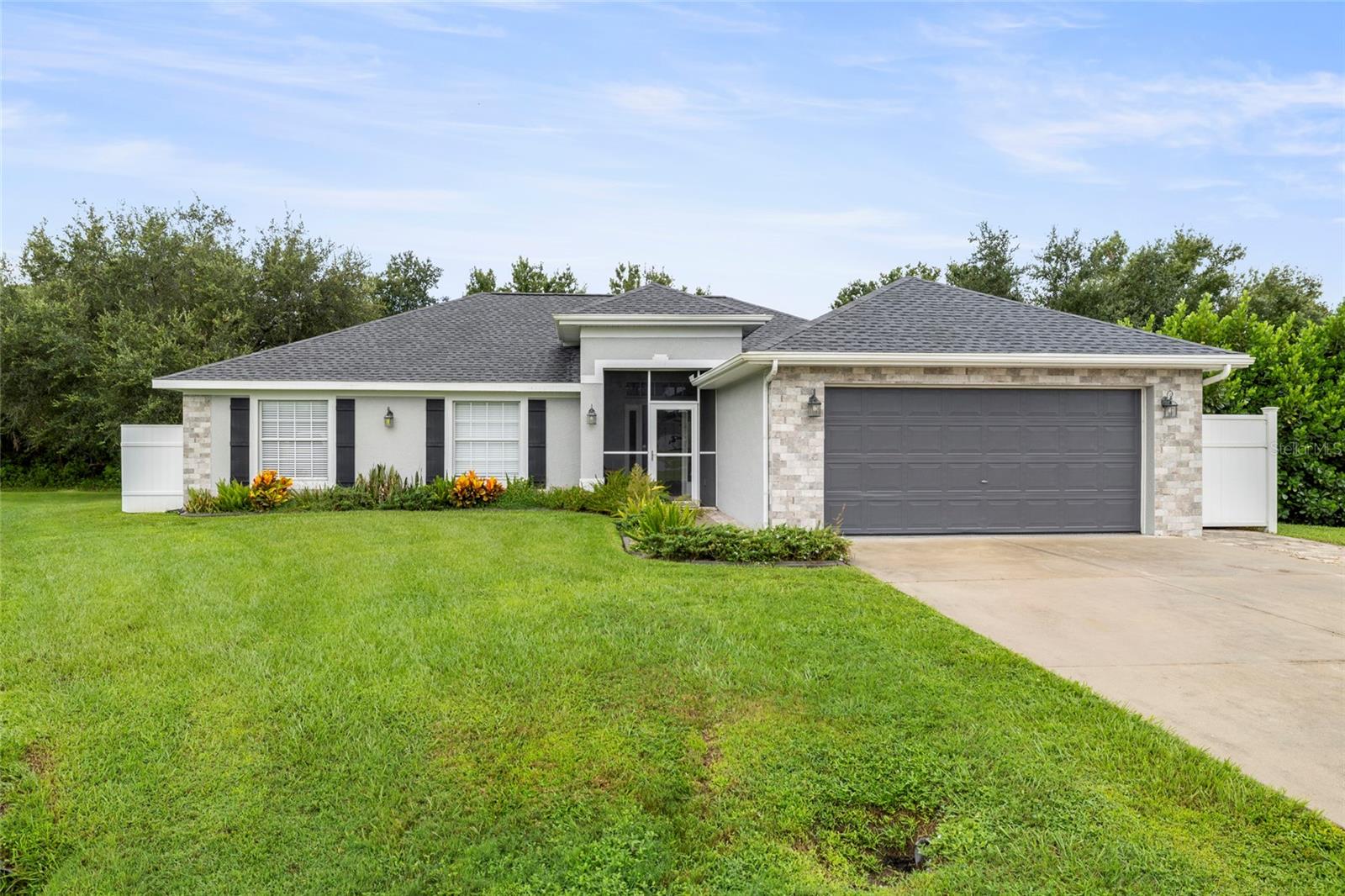 ** MOVE-IN READY, TURNKEY PERFECTION IN DEEP CREEK ** A rare opportunity, 4-bedroom pool home available on a cul-de-sac in the highly sought-after Deep Creek community — offering the rare permanent privacy of a wooded backyard. Built in the 2000s and updated throughout, this home is truly move-in-ready with BRAND NEW A/C system with UV light treatment, NEW epoxy garage floor, 50A RV outlet, and being offered TURNKEY with brand new furniture. Step inside to an open-concept floor plan with soaring ceilings, a bonus room, and timeless details designed for both comfort and entertaining. The chef’s kitchen features granite countertops, custom open shelving, American-made low-profile appliances, and reverse osmosis filtration. A spacious dining area overlooks the pool and flows into the large living room and bonus space with tray ceilings and French doors. The primary suite is a retreat of its own, with a custom built-in king bed (with lighting and fan controls at your fingertips), double vanity, walk-in closet, and a spa-like walk-in shower with a rainfall head. Step outside to your private backyard oasis * 2020 heated saltwater pool HEATED SALTWATER POOL * Sun shelf, bubbler fountain, umbrella holder & oversized bench seating * Clear-view screen enclosure * Extended paver patio for grilling and lounging. Additional highlights include * NEW ROOF * Whole-home speaker system (indoor/outdoor) * Reverse osmosis * Water softener * Large screened front porch with brick-accented curb appeal. All of this is just a short walk to the shores of the Peace River, tucked away in a quiet cul-de-sac with mature oak trees and unmatched privacy. This is more than a home — it’s the perfect blend of modern updates, move-in convenience, and serene Florida living.