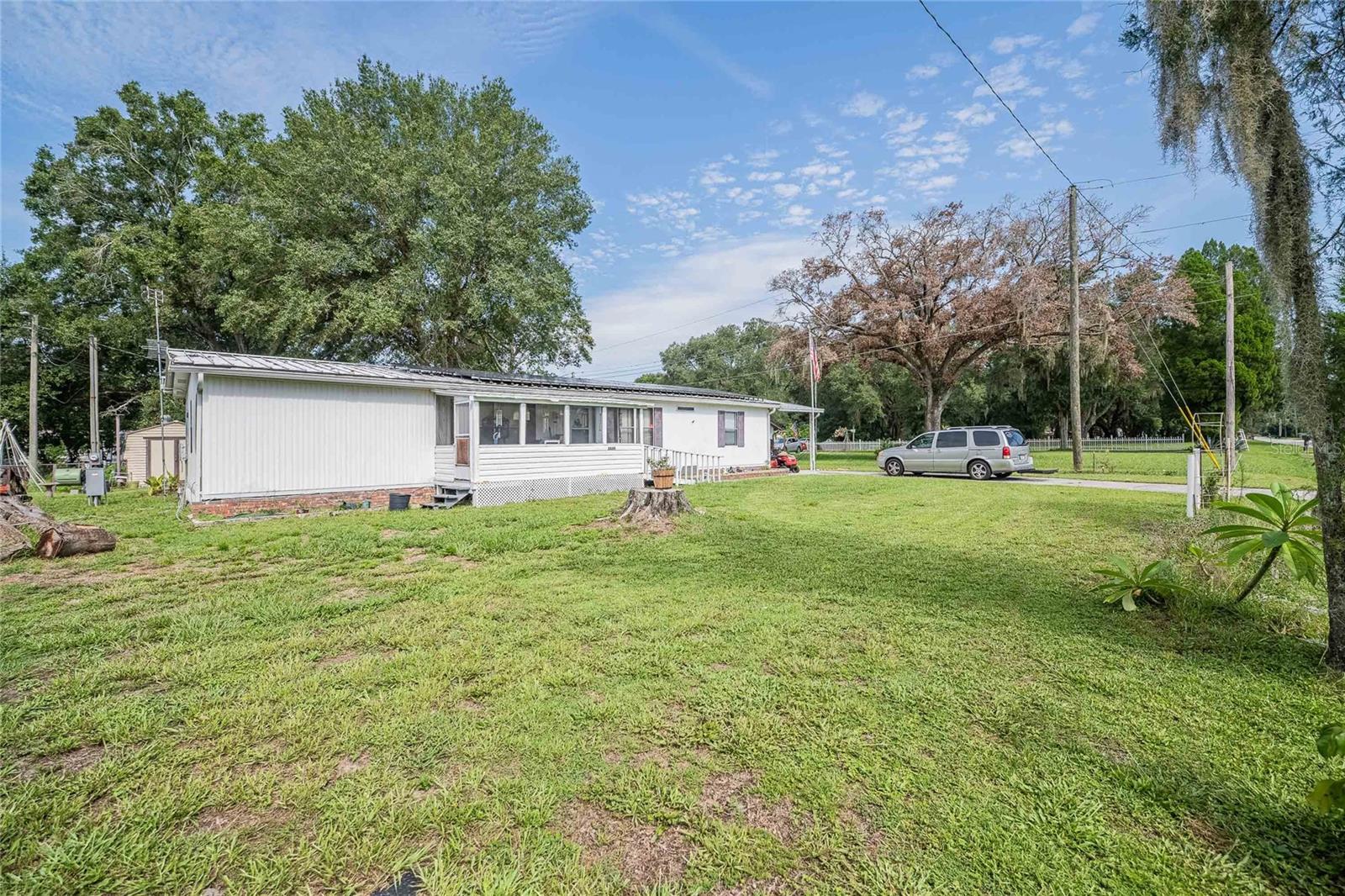 Enjoy Privacy and Freedom in Lakeland! This 3 bedroom, 2 bathroom home sits on nearly a quarter acre of land and offers the rare benefit of owning your land with no HOA or CDD fees. Located on the peaceful outskirts of Lakeland, the property provides a rural feel while still being close to shopping, restaurants, entertainment, and a quick drive to downtown Lakeland with easy access to I-4.
The home features a thoughtful split floor plan with the primary suite offering its own ensuite bath. The interior is designed for accessibility, with living space flowing seamlessly into the dining area, kitchen, and back into the living room. Two enclosed porches—one in front that is wheelchair accessible and one in back—provide additional versatile space to relax or entertain year-round. Inside laundry adds convenience.
If you’re looking for a home that combines privacy, accessibility, and convenience in a great location, this property is ready to welcome you!