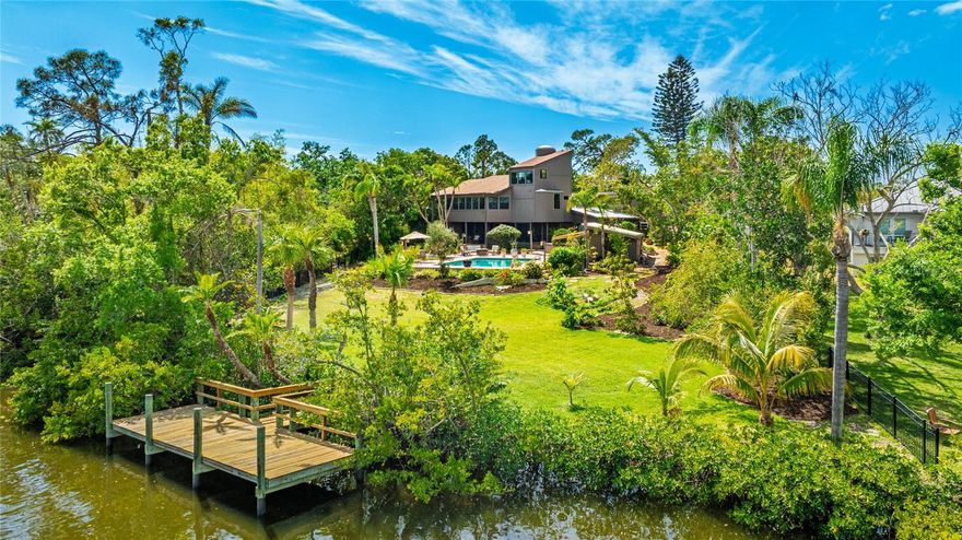 A Dream Home on Phillippi Creek – A Rare Opportunity Like No Other!
Welcome to your private creekside oasis. A true retreat-like estate nestled on over an acre of lush, waterfront property in the heart of Sarasota. This extraordinary 5 bedroom, 6 bath contemporary estate spans nearly 6,400 square feet under air, includes a Pool House and features additional detached garages, large enough to accommodate 8-cars or studio/workshops — perfect for collectors, creatives, and adventure-seekers alike. With no deed restrictions, no HOA, and no flood zone, this is the ultimate expression of freedom, privacy, and luxury living.

From the moment you step through the grand double wooden doors, you'll be captivated by the thoughtful design, custom features, and spacious elegance that define this home. The main residence offers nearly 6,000 sq ft of smart, versatile living space, including a sprawling eat-in kitchen, pantry/laundry room, formal dining room, 5 bedrooms, 5 full baths, a dedicated office/den, multiple bonus rooms, and even a library nook tucked under the stairs.
The primary suite is a true sanctuary, with dual dressing areas, oversized walk-in closets, and a spa-inspired en-suite bath. Follow the hidden spiral staircase to the third floor—a magical retreat space perfect for meditation, a yoga studio, creative writing, or a personal gym—plus access to a huge, finished attic space for extra storage or expansion. PGT impact-rated windows and doors, along with updated AC units, bring comfort and peace of mind year-round.

Step outside and take in the expansive screened-in back porch, overlooking breathtaking Phillippi Creek views, your open-air pool with sundeck, Hot Springs spa, and a separate guest/pool house—ideal for hosting guests or a home-based business. A 10’ x 26’ dock gives you direct access to the water—launch your kayak, paddleboard, or boat and embrace the best of Old Florida living.

And the garages? A dream come true. The two detached garages include a 6-car workshop/studio space and a 2-car garage—offering limitless potential for hobbyists, entrepreneurs, or RV/boat storage. You can even park your RV, trailer, or tiny home with ease—the possibilities are endless.

Other highlights include mature fruit trees, a privacy fence, and resort-style outdoor living—all just minutes from world-famous beaches, top-rated schools, fine dining, shopping, and downtown Sarasota.
Don't let this one-of-a-kind property pass you by. Be sure to explore the 3D Matterport tour and schedule your private tour today—you have to see it to believe it!  SELLER FINANCING AVAILABLE