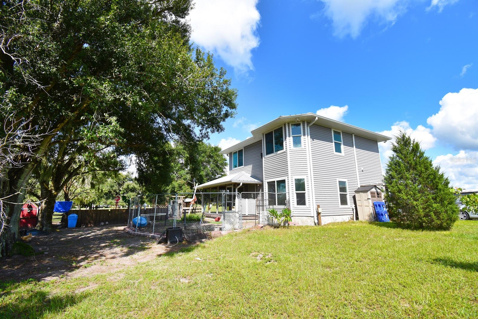 Bring your vision to this well-located home with endless potential! NO DEED RESTRICTIONS. This 2-story house has a great structure featuring a spacious floor plan with 3-bedrooms, 2-1/2 baths, office/den, UPDATED KITCHEN with quartz counter-tops, solid wood cabinets, soft close hinges and drawers. Updated appliances include 4-door Samsung stainless fridge, stainless over-size deep sink, gas range with convection and air-fry capabilities, over-the range microwave with 12" turntable. Updated panty storage area and mud room with exterior door access. SOLAR ASSIST for electric and hot water. Spray foam in attic. METAL ROOF, NEW VINYL SIDING. Living room / dining room has wood burning fireplace. 5 ACRES cross-fenced with pond; 60 x 30 WORKSHOP / STORAGE space on concrete slab, 4 GARAGE DOORS with AUTO LIFT and partial AC office space and RV hook-up; dog run; chicken coop and a cross-fenced pasture. NO HOA OR CDD fees; zoned AGRICULTURAL including horses, livestock and RVs. Great location near the new Solana Golf Course, Myakka City and close to Sarasota / Bradenton / Lakewood Ranch, I-75, UTC mall and beaches. This property is priced to sell quickly in its current AS-IS condition. Perfect for buyers looking to customize or investors seeking their next project. Don’t miss this rare opportunity!