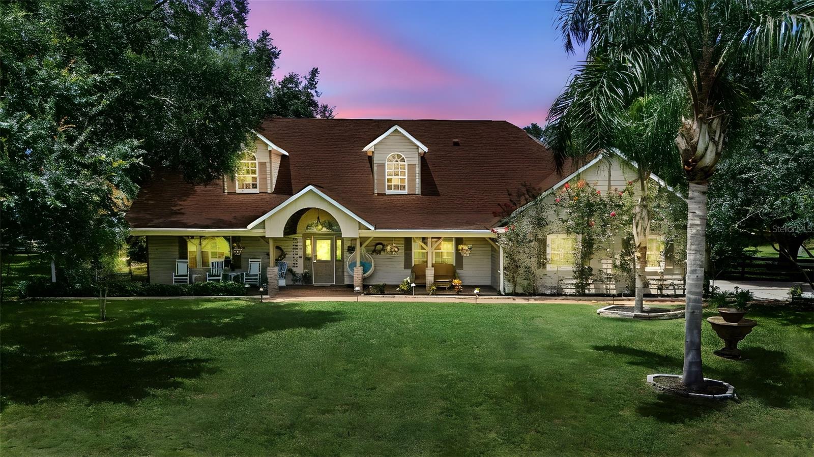 Welcome to your private retreat nestled on almost two and a half acres of serene landscape. This exceptional 4-bedroom home offers the perfect blend of comfort, elegance, and versatility, ideal for those seeking space to live, work, and entertain.
Step inside to discover soaring cathedral ceilings and gorgeous real wood flooring on the main level. The second floor boasts a wide-open loft space with two separate sitting areas. With three of the four bedrooms featuring en-suite bathrooms, there's no shortage of
privacy and convenience for family or guests.
The heart of the home opens to a beautifully designed screened-in patio, complete with a heated pool and spa — perfect for relaxing evenings or lively gatherings, all while enjoying Florida’s sunshine without the bugs. Watch the ball game or your favorite movie from the pool, and enjoy music with the patio's surround system. Built-in misters help keep the party going by keeping everyone cool and refreshed.
But the true standout lies just beyond the home: a massive 50’ x 52’ barn/garage with enough clearance to accommodate an RV — a rare and valuable feature. Whether you're a car enthusiast, business owner, or simply need substantial storage, this space delivers. It has even been leased to businesses in the past as a workshop, creating an incomegenerating opportunity. Attached to the garage is a 12’ x 36’ office building with A/C, offering a seamless work-from-home or small business setup without sacrificing your personal living space.
The expansive lot is completely board-fenced, so bring a horse or two! When you feel like a night out, downtown Mount Dora is only a five-minute drive away.
This property is a unique opportunity to own a slice of country luxury with all the modern amenities you need. The home has been meticulously maintained, and the owner is offering up to a $75,000 credit toward a new roof and buyer closing costs, as well as possible seller financing with low interest! Don’t miss your chance to experience the lifestyle this one-of-a-kind estate offers.