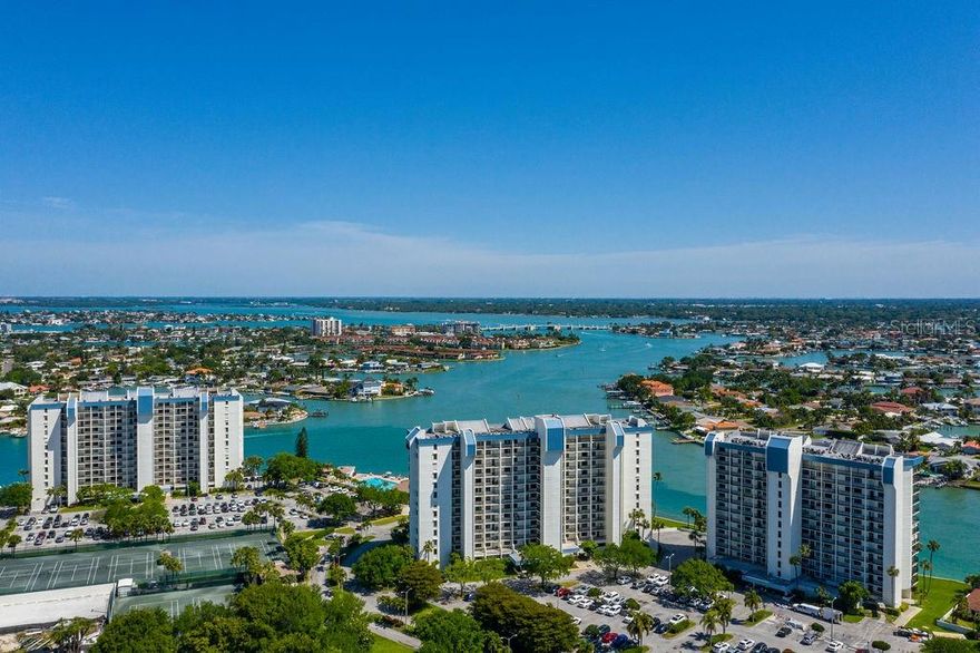 Waterfront Living, perfected at The Yacht & Tennis Club of St. Pete Beach  Awaken each morning to shimmering water views and end your day with breathtaking painted-sky sunsets from this beautifully updated 2-bedroom, 2-bath direct waterfront residence overlooking the Intracoastal Waterway. With 1,160 sq. ft. of light-filled living space, this stylish condominium has been thoughtfully designed for effortless coastal living.  Inside, an open living and dining layout is accented by coastal-inspired tile plank floors and floor-to-ceiling glass doors that frame your private balcony—an ideal retreat to watch boats drift by and sea life at play. The modern kitchen showcases sleek quartz countertops, rich solid wood cabinetry, and timeless finishes, blending function with a refined coastal palette.  Both bedrooms feature walk-in closets, a rare advantage within this community. The spacious primary suite is a serene escape with its own ensuite bath and sliding glass door access to the balcony. Recent upgrades include a premium appliance package with a bespoke glass door refrigerator offering customizable cooling zones, plus all-new ductwork and additional AC return vents for optimal comfort. A 2023 air conditioner, 2025 water heater, and high-quality updates throughout ensure true move-in readiness—with the option to purchase the gorgeous new furnishings for a turnkey experience.  Beyond the residence, the Yacht & Tennis Club spans 13 lush waterfront acres with some of the best amenities in the area. Swim in the heated waterfront pool, relax in the spa or saunas, gather in the clubhouse for social events, or stay active with tennis, pickleball, shuffleboard, and a state-of-the-art fitness center. For boaters, slips may be available for purchase, placing you just minutes from open waters.  This secure, 24/7 gated community offers the perfect balance of location and lifestyle. Sugar-sand beaches, vibrant dining, and boutique shopping are just down the road, while trendy downtown St. Petersburg—with its parks, restaurants, and nightlife—is only a short drive away. Tampa International Airport is less than an hour’s drive, making travel a breeze.  Whether you’re seeking a full-time residence or a seasonal retreat, this condominium combines elevated finishes, premier amenities, and a prime location for the ultimate Florida lifestyle. Schedule your private showing today.