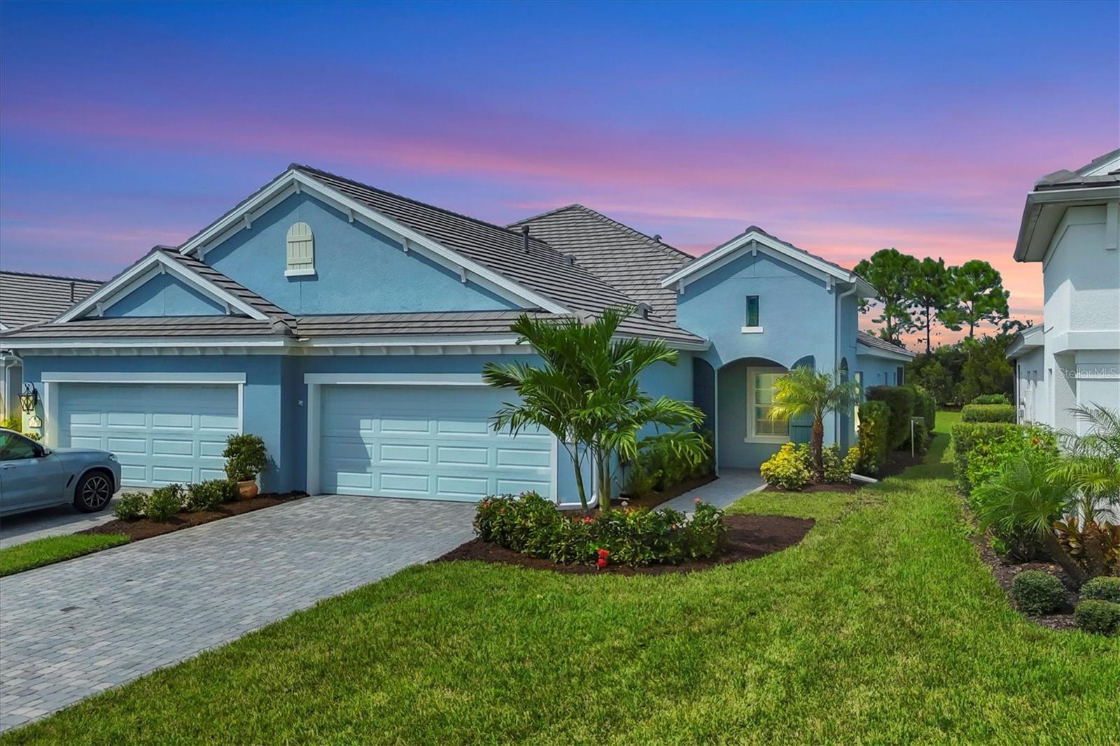Come check out this meticulously maintained, 2023 built villa located in the award winning gated neighborhood of Indigo! This meticulously cared for ''Tidewinds'' villa boasts 2 bedrooms, 2 bathrooms, a generous sized study/den, indoor laundry room, large two-car garage, extended lanai with premium pavers and super private rear conservation area! This home is situated next to a cul-de-sac AND an emergency only gate which makes this one of the quietest streets in the community. Your new villa also has ''smart home'' capabilities which allows you to remotely adjust your thermostat, open and close your garage as well as lock and unlock the front door! Rest assured your new villa is built strong and safe with its HURRICANE IMPACT WINDOWS throughout, cinder block construction, concrete tile roof AND desirable "X'' floodzone. Throughout this freshly painted villa you will find 5 1/4" deco baseboards, LED recessed lighting, 16-seer rated TRANE HVAC, ceramic tile, upgraded light fixtures, gutters and much more! The luxurious primary suite offers TWO oversized closets WITH custom cabinetry, large walk-in shower with separate his and hers vanities with quartz countertops as well. The kitchen boasts a large Island with breakfast bar, premium stainless steel appliances with exterior ventilated microwave plus LED undermount lighting that complements the premium quartz countertops. Open the three large HURRICANE IMPACT sliders and be amazed at not only the amount of room the paver rich extended screened lanai provides but your peaceful, undisturbed conservation area (NO rear neighbors). Your new lanai also comes equipped with a heightened cable connection and 110V electrical socket so no wires will be showing for any desired flat screen. The large 2-car garage comes equipped with a HURRICANE IMPACT garage door, several storage racks, ventilation which reduces the temperature inside and premium epoxy flake flooring. Indigo is an active community that features a full time on-site manager as well as a full time activities director that manages an extensive calendar of activities for all ages. A-Rated Gullett Elementary AND Mona Jain Middle school are right outside our gates too! You can also expect sidewalks on both sides of the street, ''Oasis'' pool/spa, resort style heated community pool/spa at the main clubhouse where you will find 5 cabanas with an abundance of seating, 4 pickleball courts, 2 bocce ball courts, 24-hour exercise gym, meeting room/banquet room and playground. Indigo is not only a community that takes care of all ground maintenance to include mowing, fertilizing, irrigation, shrubs and mulch but is right around the corner to a plethora of dining, banking, entertainment, public transportation and MORE!