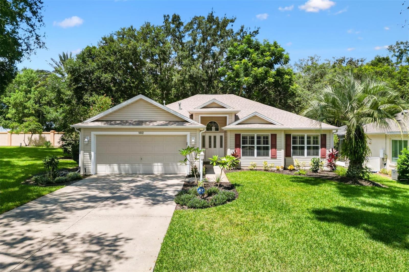 Stunning 3/2 Hamilton Designer home. NO BOND! NO CDD! NEW Roof, HVAC, Gas Hot Water Heater and Stainless Steel Appliances in 2024. Close to Sumter Landing and Spanish Springs town squares. Situated on a private lot with no homes behind , this property offers extra space, tranquil views of a lush green area, and even room for a future pool. Enter through a beautiful etched glass front door flanked by glass side panels and a transom window and step inside the inviting entry foyer with a convenient coat closet. Be greeted by soaring vaulted ceilings and luxury vinyl plank flooring throughout the home. The expansive living room is bathed in natural light from a wall of windows overlooking the beautifully landscaped garden, creating an open, airy feel perfect for both relaxing and entertaining.
The eat-in kitchen features a 5-burner gas stove, new stainless steel appliances, pull-out cabinet shelves, a center island, and a pass-through to the dining room. French doors from both the kitchen and dining room open to a wraparound enclosed lanai, ideal for enjoying morning coffee or evening cocktails while taking in the peaceful green space views.
Retreat to the master bedroom featuring a tray ceiling, large walk-in closet, and en-suite bath complete with dual vanities and a step-in shower (no tub). The split floor plan allows privacy for guests, who will appreciate the guest bath with a shower-tub combo. Additional highlights include ceiling fans with light kits, plantation shutters in the bedrooms, an attic stair kit for extra storage, gutters around the entire home, and a termite bond with Massey for peace of mind. The Hot Water Heater, HVAC system and Dryer are gas.
Just a mile to Chula Vista Recreation Center, Pool and Golf courses. Close to Spanish Springs Town Center where you’ll have access to an abundance of dining, shopping and entertainment. This location can't be beat! Don’t delay! Watch our video and make your appointment to see this house today so you can start living The Villages Dream!