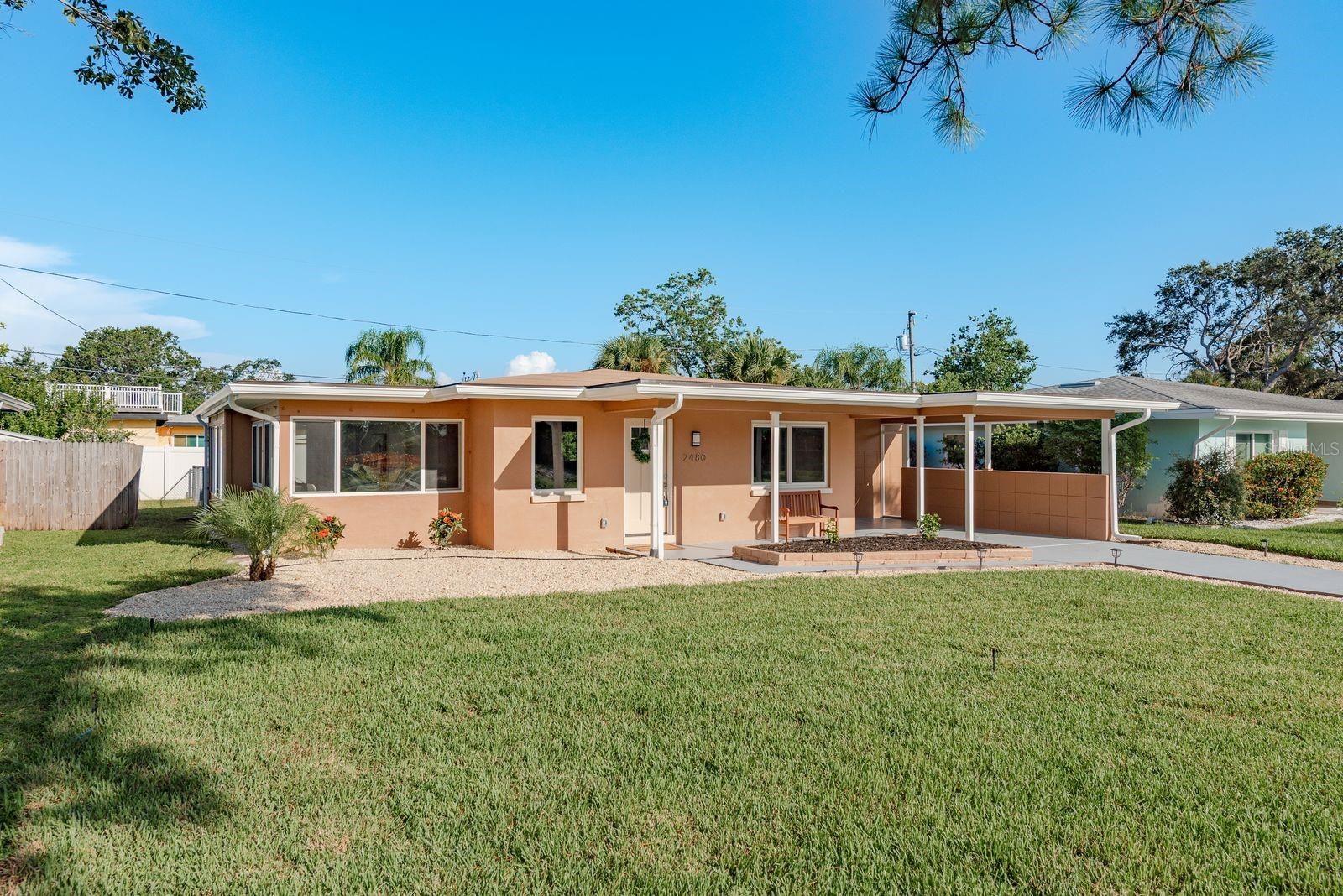 Turnkey Dunedin retreat, fully renovated from top to bottom with a bright, open split plan and sunlight pouring through the formal dining and family rooms. A magazine-worthy kitchen anchors the living space, complemented by tile bathrooms, tasteful lighting, and sleek ceiling fans. Virtually everything brand new (2025): new roof, AC, water heater, updated plumbing with all new drain lines to the street so there is no cast iron under the house, updated electrical, and luxury vinyl flooring throughout. The private primary suite offers its own exterior entry and a primary bath with washer and dryer hookup, perfect for multigenerational living, guests, or a home office. In the family room, an electric fireplace with a reclaimed-wood surround and floating shelves delivers warm modern character. Outdoors, enjoy a fully fenced backyard, detached storage shed, fresh front-yard sod with pea-gravel accents, a newly coated driveway, and fresh paint inside and out. Seller is offering an assumable flood insurance policy with the premium paid through April 2026, buyer to verify eligibility. Minutes to quintessential Dunedin living: Dunedin Golf Club, Highlander Park, the Causeway, and world-class beaches at Honeymoon Island.