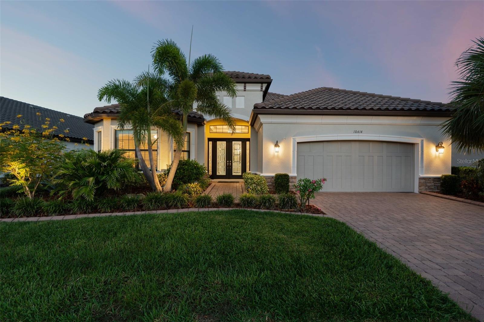 Looking for your own piece of paradise? Welcome to this stunning Pallazio home in the highly sought-after, maintenance free Esplanade at Artisan Lakes. Offering over 3,000 sq. ft. of indoor living space, this meticulously cared-for and beautifully upgraded home blends elegant design with true Florida resort-style living.
The freshly painted exterior is enhanced by custom landscaping with curbing and lighting, giving this home exceptional curb appeal day and night. Step inside through gorgeous leaded glass double doors and you’re welcomed into a sprawling open-concept floor plan filled with natural light, soaring ceilings, and elegant designer touches. Your eyes are immediately drawn to the back of the home, where a wall of glass pocket sliding doors opens to your private outdoor oasis. This retreat is the true highlight—featuring a heated pool and spa, a fully equipped outdoor kitchen, and an expansive screened in lanai with long pond views. With no neighbors behind the home and new Florida glass on the lanai, you’ll enjoy enhanced privacy and a serene backdrop. At night, the pool and landscape lighting transform the space into a resort-like escape, ideal for relaxing evenings or entertaining under the stars.
Inside, plantation shutters, tray ceilings and crown molding throughout add sophistication, while custom lighting and chandeliers in the foyer and dining room create a warm ambiance. Chair rail and mirrors in the formal dining room further elevate the style.
The gourmet kitchen is a chef’s dream with quartz countertops, a large center island, upgraded cabinetry with pull out drawers, and stainless-steel appliances—perfect for both everyday living and entertaining. The spacious living and dining areas flow seamlessly to the outdoors, creating the ultimate setting for gatherings.
The owner’s suite offers a peaceful retreat with a spa-like bath and custom closets, designed for both style and functionality. Two additional bedrooms and a versatile den provide flexibility for guests, a home office, or a hobby space.
Living in Esplanade at Artisan Lakes is like being on vacation every day. With maintenance free living, two incredible clubhouses to enjoy and a lifestyle event manager organizing countless social activities living in Esplanade is like being on vacation. The community offers two resort style pools and spas, pickleball, tennis, bocce ball courts, cornhole, a gym, firepit, dog parks, and a playground. Located just off I-75 and I-275, you’re only minutes away from pristine Gulf Coast beaches, charming downtown areas, and all the shopping, dining, and entertainment you could desire. Whether you’re heading to Sarasota, St. Pete, or Tampa, you’re perfectly positioned for easy access to the best of Florida’s Suncoast. Don’t miss out on this rare opportunity—schedule your private showing today and start living the Florida dream!
Click on links for video and virtual tours!