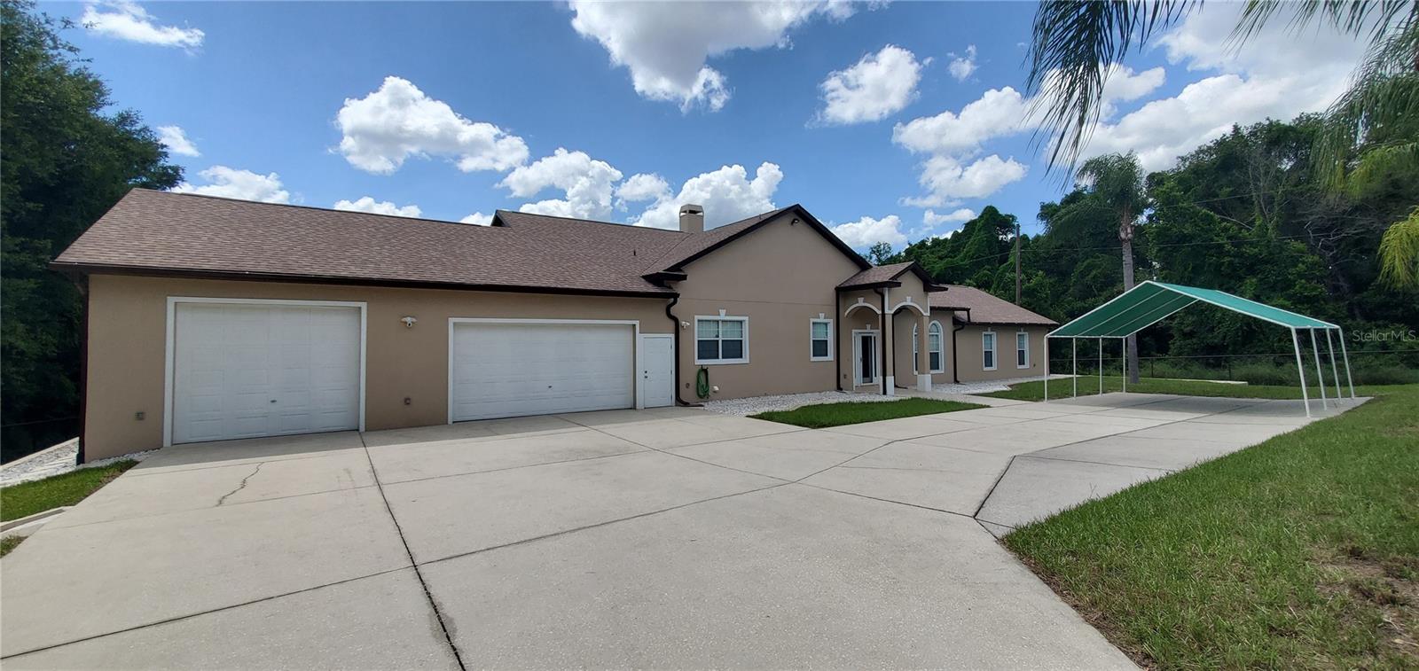MUST SEE! Step into this stunning 2002 CUSTOM BUILD BLOCK home in prime location. This 2,492 sq ft home offers 4 spacious bedrooms, 3 bathrooms, and a BONUS OFFICE. Nestled on a peaceful .86- acre OVERSIZED LOT, it boasts a private wooded preserve as its backyard view. The home features an impressive 200-foot palm tree- lined driveway leading to the property, which is fully enclosed by a 6-foot painted fence and an ELECTRIC GATE with keypad access for added security. The oversized 3-car garage is equipped with NEW EPOXY POLYASPARTIC FLOORING, built-in shelves, and dual oversized garage doors for easy access. An additional 18 x 10 concrete pad in the back provides extra space for parking or storage. Enjoy the serene backyard with a large 100 x 150 area, a log rack, and a spacious burn pit for entertaining. The back patio has been NEWLY RE-SCREENED AND PAINTED. Inside, the OPEN FLOOR PLAN features SPLIT BEDROOMS, with a FRESHLY PAINTED INTERIOR and BRAND NEW CARPET throughout. The home includes a SURROUND SYSTEM with speakers in the kitchen, dining, living room, and back patio. The BUILT- IN ENTERTAINMENT CENTERS in the living room and primary add to the modern conveniences. Built with storage in mind, this home features room for everything—and then some! Recent updates include a BRAND NEW REFRIGERATOR (2025), BRAND NEW WASHER and DRYER (2025), NEW ROOF (2022), NEW HOT WATER HEATER (2023), and FRESHLY PAINTED EXTERIOR and INTERIOR. This turn-key home is ready for you to move in and enjoy!