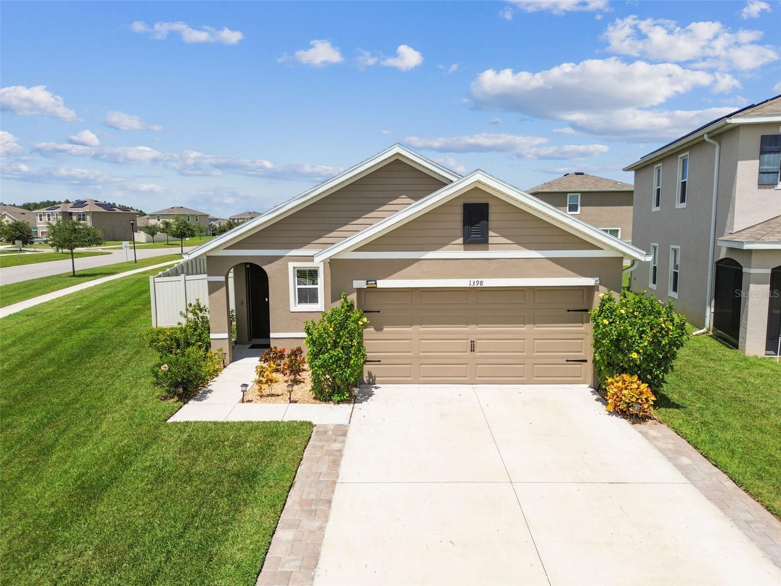 Welcome to 1398 Crescent Hoop Way, a beautifully designed 3-bedroom, 2-bath home, perfectly situated on an OVERSIZED CORNER homesite. This thoughtful floor plan offers inviting spaces inside and out. The primary suite is tucked at the back of the home for maximum privacy, with convenient access to the EXTENDED COVERED LANAI, perfect for enjoying quiet mornings or unwinding in the SPA after a long day. Inside, the suite features dual sinks, a spacious walk-in shower, and a large walk-in closet. At the heart of the home, the kitchen flows seamlessly into the living room, creating an open and welcoming space for everyday living or entertaining. The kitchen is complete with GRANITE countertops, STAINLESS STEEL appliances, and plenty of counter space. The secondary bedrooms feature warm WOOD flooring, while the main living areas are finished with durable TILE, blending style with functionality. Step outside to the EXTENDED COVERED LANAI, upgraded with PAVERS in a beautiful FRENCH PATTERN, an ideal setting for dining, relaxing, or hosting friends. The fully FENCED backyard provides a generous outdoor retreat with space to play, garden, or simply enjoy the privacy of your own corner lot. This home truly combines comfort, style, and outdoor living. Union Park offers its residents an ideal homeowner experience featuring a resort style pool, lap pool, clubhouse, fitness center, splash pad, dog park, zen garden, playground and miles of biking and walking trails. Schedule your private tour of this exceptional home today! Don’t miss the chance to make it yours!