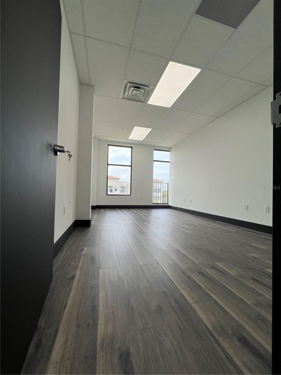 Discover a fully finished and never-before-occupied professional office suite located in the heart of Hunters Creek – one of Orlando’s most desirable commercial corridors. This modern office condo features four spacious cubicles, high-end finishes, and ample natural light, offering a move-in ready environment ideal for professionals, consultants, or small businesses.
Enjoy a fully equipped kitchenette, complete with microwave, hot water, custom cabinetry, and elegant countertops. The space also includes pre-installed plumbing infrastructure for a future private bathroom, making this unit a rare opportunity with added flexibility for future upgrades.
Located in a new, professionally managed commercial complex built in 2023, this unit is part of a stylish and energy-efficient Class A building, with ample parking, ADA-compliant access, and low-maintenance costs.
Situated in the highly sought-after Village at Hunters Creek, with quick access to John Young Parkway, SR-417, and the Florida Turnpike, this location offers superior connectivity to downtown Orlando, Lake Nona Medical City, and Orlando International Airport. Surrounded by national retailers, banks, medical offices, and residential communities, this office is perfectly positioned for success.
Highlights:
• Brand-new office space with 4 cubicles
• Fully finished and furnished kitchenette
• Hot water installed; plumbing ready for future private bathroom
• Class A construction (2023), modern design
• Ample surface parking, secure access
• Strong demographics and foot traffic
• Easy access to major highways and commercial hubs
Ideal for medical, legal, insurance, tech, or consulting professionals. Schedule a private showing today!