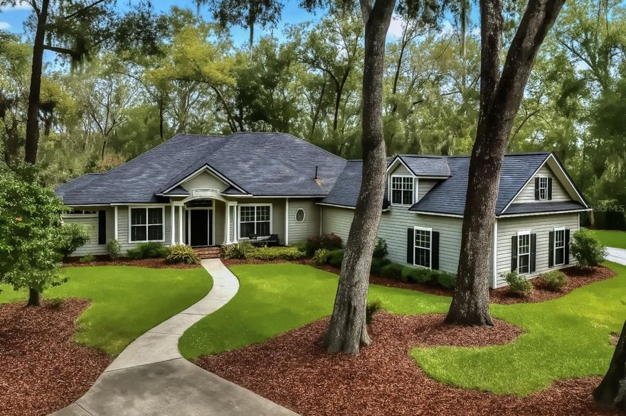 - Gated Acreage Pool Home Minutes from UF - 
 
Welcome to 14312 NW 41st Ave, Newberry — a 5-bedroom, 5-bath custom estate in Steeplechase Farms, one of Alachua County’s most desirable acreage communities.

Set on 1.78 professionally landscaped acres with no rear neighbors, this 4,100+ sq. ft. home blends timeless design with modern livability. Inside, soaring vaulted ceilings and a stone-accented fireplace anchor the main living space, with wide-open views across the screened lanai and full-size pool with generous deck space for seating and entertaining.

The flexible floor plan includes:

Spacious main-level primary suite with pool access and dual closets.

Three additional bedrooms plus a private upstairs suite — perfect for guests, multi-generational living, or a creative studio.

Formal and informal gathering areas, plus a kitchen designed for both prep space and entertaining.

Recent system updates and low-maintenance landscaping make everyday living seamless. Outside, enjoy:

Screen-enclosed pool with extended deck and covered lanai, designed for year-round Florida use.

Expansive lawn shaded by mature oaks.

Private gated drive set well back from the road.

Homes in Steeplechase with this combination of space, privacy, and a standout pool plus quick access to UF, Tioga, Publix, and top-ranked schools are rarely available.