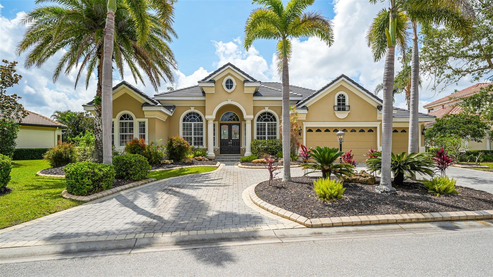 Brand New beautiful flat Tile Roof has been installed! (May 2025) In the sought-after Legends Walk neighborhood of the prestigious Lakewood Ranch Golf & Country Club, this former Peregrine model home offers just under 3,800 square feet of casual elegance and provides the ideal country club and Lakewood Ranch lifestyle. The Neo-Classical style elevation with its lush landscaping and a brick paver circular driveway provides a welcoming curb appeal. Upon entering its bright, open and spacious Hampton floor plan with soaring ceilings, you are immediately captured by its charm. This gem offers three bedrooms, three full and one half bath, a three-car 23-by-28-foot garage, an office/study that boasts built-in book shelves and a desk, a bonus/flex room in the rear of the home affording serene lake and preserve views, a formal living room with a granite and stone-facing fireplace, a formal dining room, a family gathering room in the heart of the home with tall sliders opening to the pool for inside and outside blending, and a gourmet chef's delight kitchen with maple raised panel white cabinets, a 36-inch Sub-Zero refrigerator and 36-inch freezer, a double wall oven with Advantium convection, conventional and microwave cooking options, a walk-in pantry, stainless steel appliances and a distinctive center island with 1.25-inch neutral granite counter tops. Accents throughout the home include 20-by-20-inch porcelain tiles, custom wood flooring in the bonus room and the office, and wood flooring in the bedrooms, detailed architectural appointments, crown molding, plantation shutters, designer lighting fixtures, decorative ceiling fans and high ceilings with even higher tray ceilings making the rooms feel even larger. Other features include a new water heater in 2024, two air-conditioning units with one replaced in 2022, a wet bar between the kitchen and dining room with glass display cabinetry and a wine refrigerator, a fenced dog run, tall sliders which provide seamless access to the expansive outdoor private retreat that offers a heated pool and spa, a built-in GE Monogram grill, a stone fireplace, extensive open and undercover spaces all overlooking a private and peaceful lake with a preserve setting behind it. The owner’s retreat has its private wing with a door to the lanai, two California customized walk-in closets, dual sinks, and features a luxurious spa-like bath with an opulent Roman tub area with marble deck. LWR Golf & CC offers non mandatory memberships at different amenity levels including four 18-hole championship courses, tennis, pickleball, fine and casual dining and two restaurants, clubhouse, fitness center and lap pool. Close to shopping, restaurants, public golfing, cultural venues of Sarasota and its award-winning beaches. This home is a must-see!