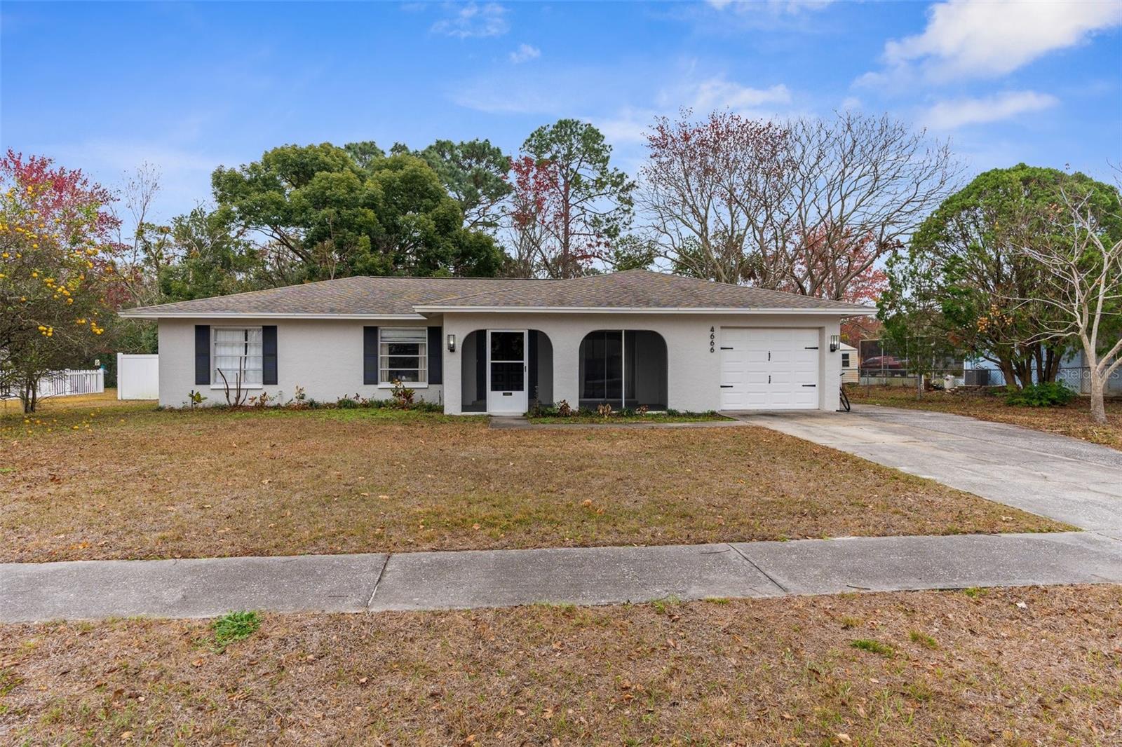 This charming 3-bedroom, 2-bathroom, 1 car garage home in Spring Hill, Florida, offers the perfect blend of comfort and convenience on an oversized, FENCED IN lot. Recently updated with modern finishes, the home features, a newer AC unit (2022), a newer roof (2021), updated flooring and new carpet in the bedrooms, and a renovated kitchen with sleek countertops, beautiful backsplash and newer appliances. Spacious living areas provide plenty of room for both relaxation and entertaining, while the generously sized lot offers endless possibilities for outdoor activities, gardening, or future expansion. The driveway is expanded and has room for RV or boat parking OR could be turned into a private basketball court for fun! Large screened in and covered back porch make outdoor living enjoyable. Located in a desirable neighborhood with great schools, this affordable, move-in-ready home is a true gem with all the upgrades you're looking for! Call today for more information before this one is gone!