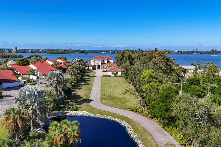 Premier Intracoastal Estate in Osprey
4 Bedrooms | 6 Bathrooms | 6,308 Sq. Ft. | 2 Waterfront Acres
A rare opportunity to own two acres of private waterfront property in Sarasota, 730 Sarabay is a
convergence of residential luxury and unparalleled waterfront living. The two-story home sits at
the end of a long drive behind a gated entrance and tranquil pond. With approximately 100 feet
of bay frontage, the property provides an uncommon level of seclusion. A private dock and boat
lift rated for 15,000 pounds offer instant access to Little Sarasota Bay. With no fixed bridges in
the way, vessels of any height can sail straight through Midnight Pass into the Gulf of Mexico.
Unlike almost every other waterfront property in Sarasota County, this elevated acreage offers higher ground for added peace of mind.
 The house features soaring ceilings
and wide-plank oak floors. Its over-sized hurricane-impact glass fills the rooms with light.
Generous living and dining areas, as well as a handsome office and bonus room with water
views, flow in a blend of open-plan and formal spaces, accommodating family gatherings and
grand festivities. The gourmet chef’s kitchen is equipped with solid wood cabinetry, stone
counters, and high-end appliances. The primary suite, conveniently located downstairs, features a
broad view of the bay, vaulted ceiling, spa-like bath, and capacious closets. Reached by
travertine staircase or wood-paneled elevator, the second floor houses three ensuite bedrooms,
one of which serves as a second master. Each offers stunning bay views, a full bath, and ample
closets. A bonus room usable as guest suite, home gym, or playroom, completes the upstairs. The
generously sized travertine patio and bayside lawn are an oasis for outdoor living and gracious
entertaining. The pool features a Baja shelf and integrated spa, and the propane fire pit creates a
cozy spot for cooler evenings. The covered living and dining area commands spectacular views
of the vivid South Florida sunsets. Recent upgrades include two new AC units, a new pool
heater, and a newly painted exterior. Characterized by long lawns and mature palms, the grounds
are a low-maintenance blend of lush beauty and complete privacy. The attached 4-car garage is
proportioned for contemporary vehicles. It includes a built-in workbench with capacious
cabinetry. The free-standing 3-car garage is divided into two and one-car bays, easily customized
for personal use. The two-bay side was an artist’s studio and includes a mini-split and large
laundry sink. The one-bay side overlooks the garden and was previously a home gym. Location
is the most important factor in real estate, and this property delivers. Positioned near A-rated
Pine View School and Oscar Scherer State Park, 730 Sarabay is adjacent to Downtown Sarasota,
convenient to St. Armands, and close to Historic Venice and world-renowned Siesta Key Beach.
This home is a complete waterfront lifestyle, a legacy estate where memories are made and
treasured for generations.