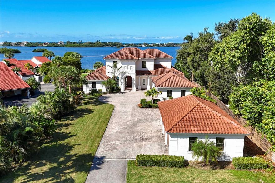 Premier Intracoastal Estate in Osprey
4 Bedrooms | 6 Bathrooms | 6,308 Sq. Ft. | 2 Waterfront Acres
A rare opportunity to own two acres of private waterfront property in Sarasota, 730 Sarabay is a
convergence of residential luxury and unparalleled waterfront living. The two-story home sits at
the end of a long drive behind a gated entrance and tranquil pond. With approximately 100 feet
of bay frontage, the property provides an uncommon level of seclusion. A private dock and boat
lift rated for 15,000 pounds offer instant access to Little Sarasota Bay. With no fixed bridges in
the way, vessels of any height can sail straight through Midnight Pass into the Gulf of Mexico.
Unlike almost every other waterfront property in Sarasota County, this elevated acreage offers higher ground for added peace of mind.
 Across fourteen hurricane seasons since 2011, this elevated 2-acre estate has maintained a flawless record: no water intrusion, no flooding, and no structural damage — per sellers’ disclosures spanning two ownerships. In Sarasota County’s waterfront market, such documented elevation advantages are exceptionally rare. 
Soaring ceilings and wide-plank oak floors define the interiors complemented by Oversized Hurricane-Impact glass that fills the homewith natural light. 
Generous living and dining areas, as well as a handsome office and bonus room with water
views, flow in a blend of open-plan and formal spaces, accommodating family gatherings and
grand festivities. The gourmet chef’s kitchen is equipped with solid wood cabinetry, stone
counters, and high-end appliances. The primary suite, conveniently located downstairs, features a
broad view of the bay, vaulted ceiling, spa-like bath, and capacious closets. Reached by
travertine staircase or wood-paneled elevator, the second-floor houses three ensuite bedrooms,
one of which serves as a second master. Each offers stunning bay views, a full bath, and ample
closets. A bonus room usable as guest suite, home gym, or playroom, completes the upstairs. The
generously sized travertine patio and bayside lawn are an oasis for outdoor living and gracious
entertaining. The pool features a Baja shelf and integrated spa, and the propane fire pit creates a
cozy spot for cooler evenings. The covered living and dining area commands spectacular views
of the vivid South Florida sunsets. Recent upgrades include two new AC units, a new pool
heater, and a newly painted exterior. Characterized by long lawns and mature palms, the grounds
are a low-maintenance blend of lush beauty and complete privacy. The attached 4-car garage is
proportioned for contemporary vehicles. It includes a built-in workbench with capacious
cabinetry. The free-standing 3-car garage is divided into two and one-car bays, easily customized
for personal use. The two-bay side was an artist’s studio and includes a mini-split and large
laundry sink. The one-bay side overlooks the garden and was previously a home gym. Location
is the most important factor in real estate, and this property delivers. Positioned near A-rated
Pine View School and Oscar Scherer State Park, 730 Sarabay is adjacent to Downtown Sarasota,
convenient to St. Armands, and close to Historic Venice and world-renowned Siesta Key Beach.
This home is a complete waterfront lifestyle, a legacy estate where memories are made and
treasured for generations. Explore the virtual tour for a full walk-through of this updated 2-acre waterfront home.