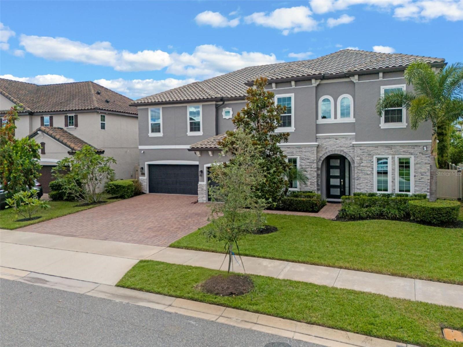 Living in Orlando means every day can feel like a vacation and this home makes it possible.
Located in the heart of Dr. Phillips, this beautifully maintained 5-bedroom, 4.5-bath home offers the perfect balance of modern design, thoughtful details, and an ideal floor plan for today’s lifestyle while surrounding you with everything that makes Orlando living feel like a year-round vacation.
In addition to the 5 bedrooms, you’ll enjoy an OFFICE/FLEX ROOM, MEDIA ROOM AND LOFT with a built-in bar and walk-in storage. The first floor is designed with MULTI-GENERATIONAL LIVING in mind, featuring a private IN-LAW SUITE with a walk-in closet and full bath with a walk-in shower AND A PRIVATE ENTRANCE. The main level also includes a formal dining room, spacious family room, powder bath, and an office/flex space.
Upstairs, the luxurious primary suite serves as your own private retreat, joined by 3 additional bedrooms, 2 full bathrooms, a media room, and a well-appointed laundry room with custom cabinetry. And YES, the WASHER AND DRYER ARE INCLUDED.
At the heart of the home, the gourmet kitchen shines with an oversized island, walk-in pantry, dedicated coffee/tea bar, and a large casual dining area perfect for gathering with family and friends.
Notable features include soaring 10’ ceilings on the first floor and 9’ ceilings upstairs, 8’ doors throughout, expansive Low-E windows for natural light, custom shades and all-block construction with spray foam insulation and temperature-regulated attics for energy efficiency. Built in 2018, the home has been meticulously cared for, with recent updates including fresh interior paint (2025), exterior pressure wash and lanai floor painted (2025), sealed paver driveway and walks (2025), and exterior paint (2024). A full list of updates is available.
Outdoor living is just as inviting, with a spacious screened lanai overlooking a fenced backyard enhanced with rare exotic fruit trees (plum, peach, banana, kumquat, fig), Graceful clumping bamboo (non-invasive) for privacy, and a play set. The oversized 3-car garage includes overhead storage and racks.
The Estates at Parkside is a virtual guard-gated community offering private access to the adjacent elementary school, a clubhouse, pool, and playground. Best of all, you’re only minutes from world-class dining on Restaurant Row, O-Town West, Dr. Phillips Community Park, Bay Hill Golf Course, and Orlando’s famous theme parks…Universal, Disney, and SeaWorld.
Here, everyday life feels like a vacation. From resort-style amenities and year-round sunshine to the unmatched convenience of Dr. Phillips, this home delivers the dream lifestyle Orlando is known for.