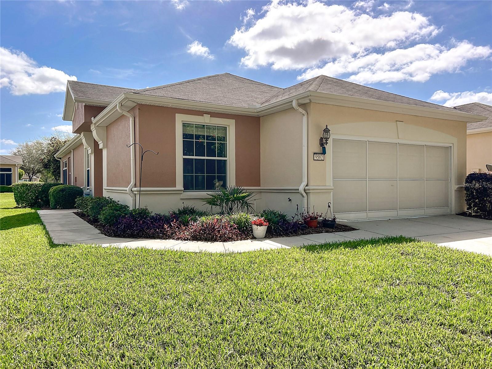 Discover carefree living in this beautifully maintained Alexander Villa, perfectly suited for those desiring convenience and comfort. With 2 spacious bedrooms, 2 full bathrooms, a versatile flex room, and an attached 2-car garage, this home effortlessly combines practicality and style.
Enjoy an airy, open-concept layout enhanced by elegant tile flooring throughout the main living areas and bathrooms. The well-appointed kitchen features sleek Corian countertops, modern recessed lighting, and a charming café nook perfect for casual dining. Additionally, a formal dining space is available for gatherings and entertaining.
Relax in the inviting living room, which includes a ceiling fan, a stylish credenza (newly added in 2021), and sliding glass doors opening seamlessly onto the enclosed lanai. The primary bedroom offers comfort with a ceiling fan, generous walk-in closet, and an en-suite bath featuring an updated shower (new glass doors in 2020) and solid surface vanity. Guests will appreciate the second bathroom's bathtub and matching vanity countertops.
The flexible den, adorned with attractive glass French doors, can easily serve as an office, reading room, or additional guest space. The dedicated laundry area adds convenience with a utility sink and a substantial folding countertop. Step out to the enclosed lanai, beautifully appointed with floor-to-ceiling sliding windows, transom accents, and durable tile flooring—ideal for year-round enjoyment.
Additional enhancements include a new Franklin furnace installed in 2019 and a premium Culligan water system. Welcome home to effortless elegance and low-maintenance living.