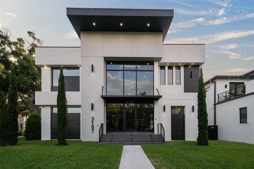 Nestled in Sunset Park, this contemporary masterpiece boasts 7 beds, 8.5 baths, and unrivaled architectural design. The grand
entrance features 24' ceilings and a floating staircase, leading to a dining room with a wine cellar. The chef's kitchen dazzles with
Calcutta Marble countertops, Thermador appliances, and a hidden pantry. The great room, den, and en-suite bedroom complete the
first floor. Upstairs, the primary suite offers a walkout balcony and lavish ensuite bath, alongside five additional bedrooms and a
media room. The third floor impresses with a marble waterfall countertop whiskey bar, leading to a rooftop terrace. Outside, a
saltwater pool, spa, and outdoor kitchen await in the tropical oasis backyard. Additional features include a glass entrance, security
cameras, 3-car garage, and elevator. Just minutes from Tampa's amenities, this home epitomizes luxury living.