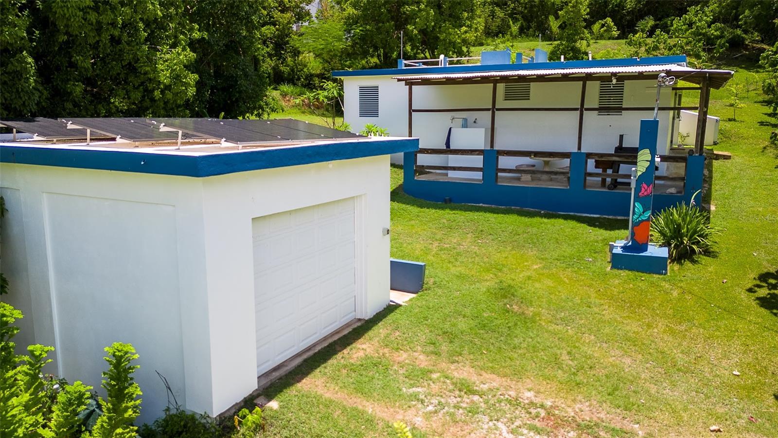 Turnkey 2-Bedroom Gem with Solar + Water System in Bravos de Boston, Vieques, Puerto Rico
Located at the quiet end of a peaceful street in Bravos de Boston, this beautifully maintained 2-bedroom, 2-bathroom concrete home is move-in ready and built for both comfort and resilience. Set on 0.40 acres with mature bananas, citrus, frangipani, and bougainvillea, it offers a blend of privacy, sustainability, and tropical charm.
The spacious primary bedroom features an ensuite bathroom with an oversized shower with 2 shower heads and opens directly onto a private patio—a perfect retreat. Modern doors and windows throughout bring in natural light and island breezes. A rooftop patio offers a prime spot for stargazing and the beach is a short 5 minute walk away.
Over 1,000 square feet of living space plus a generous 400 sq ft garage/workshop give ample room for storage, hobbies, or creative projects.
Notable features include:
Atmospheric water generator/dispenser (produces up to 10 gallons/day) in addition to public water connection
Grid-tied solar system with assumable equipment lease plan
Fully furnished, turnkey condition
Lush landscaping with fruit trees and flowering plants
Excellent area in the tiered backyard to add a casita and enjoy the water views
Please note: This is a cash-only sale due to unregistered title.Â
A well-built, well-equipped island home in excellent condition—ready for your immediate enjoyment.