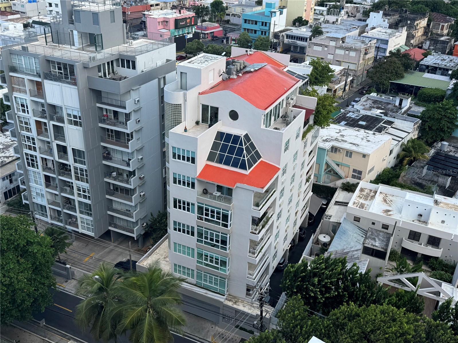 Worldly Sophistication meets a Modern Aesthetic in this one-of-a-kind meticulously crafted architectural masterpiece conceived by renowned José "Cheo" Camacho. This expansive 6,016 SF 3-level bespoke Penthouse perched in the top floor of McLeary 1800 Condominium, is located in the prime and stylish Ocean Park community, known for its laid-back, residential beach vibe and often referred to as ‘Little Malibu’. This boutique and intimate condominium with 10 residences is conveniently positioned just steps to the beating heart of urban Condado, a block from the beach and a short stroll to world-class entertainment, restaurants and some of the top schools in the city. Step out of a private keyed elevator directly into your home and arrive at a pleasing foyer that leads you to the grandiose living and dining area. These luminous spaces filled with natural light permeate the polished venetian plaster finished ceilings and walls, illuminating the elegant multi-dimensional textured floors. Be amazed by the brilliantly concealed spaces in the main level, which includes a private service ‘maids’ room with a full bathroom, a guest half bathroom and built-in storage throughout, meticulously hidden behind impressive custom-made flushed walls and doors that adds to its minimalist appeal. At the rear of the formal dining room is the sophisticated and modern custom designed Italian Boffi Kitchen with Stainless Steel Subzero and Miele appliances. The Boffi kitchen emphasizes the value of luxurious and simple materials, treated wood finishes, and stones in different densities. Flooded with natural light from its plethora of windows, the kitchen was designed in a fresh white color palette, with abundant counter space and smart storage areas, sure to satisfy the most discerning demands of any top chef. Adjacent to the kitchen, a convenient peninsula seating area and a separate family room with vibrant city views perfectly compliment the space. An astonishing double grand staircase becomes the residence centerpiece connecting all 3 levels of the home. This dramatic staircase combining aluminum, stone and wood materials form the perfect balance and mood. As its backdrop, a cathedral glass wall featuring a greenhouse overlooking luscious, bright verdant trees complete the experience. In the lower level, you will be greeted by a family room followed by a Primary Suite, 3 additional sizable bedrooms and Laundry Room. Each bedroom features abundant closet space and its own modern and private bathroom with Phillip Starck fixtures. As you ascend to the third and upper level, a lavish entertainers dream awaits. Beautifully conceived family and dining areas with double height ceilings was created in perfect harmony with the elements, lighting, and space. The family room features a Sonos Home theater setup with a projector screen. To top it off, an additional Boffi kitchen with Miele and Sub-Zero appliances and a guest bathroom complete the space. Take a breath of fresh air or create an indoor-outdoor experience for your guests once you open the pocket glass doors that lead you to an intimate, green rooftop terrace. Whether you want to host sunset cocktails ‘al fresco’ or sunbathe while reading your favorite book in the privacy of your home, this unique outdoor amenity will not disappoint. 1800 McLeary Condominium offers a full power generator. The home includes two side by side covered parking spaces and an ample storage room with the purchase.