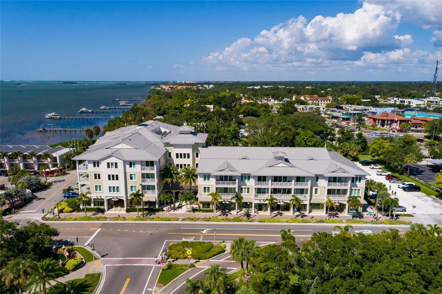 Experience luxury living in the heart of downtown Dunedin at Victoria Place, the city’s premier condominium community. Ideally, across from Edgewater Park, the marina, and the waterfront, this residence offers award-winning construction, maintenance-free living, and the security of a private, secure building. This stunning second-floor remodeled condominium has been upgraded throughout. Natural light fills the open living spaces, creating an inviting and airy feel. The chef’s kitchen showcases a spacious island, designer cabinetry, quartz countertops, custom backsplash, under-cabinet lighting and top-tier appliances. A stylish butler’s pantry with dual wine and beverage refrigerator adds elegance and convenience. Entertain with ease in the beautiful dining area and welcoming living room, which opens to a private patio—ideal for morning coffee or evening wine. Two bedrooms and two full baths are thoughtfully designed with high-end finishes. The luxurious primary suite boasts enhanced crown molding, blackout window treatments, dual closets and a spa-inspired en-suite bath with an upgraded walk-in shower, glass enclosure and modern vanity. The guest bedroom easily doubles as a home office or den. A dedicated laundry room with stackable washer/dryer adds everyday convenience. Additional highlights include two assigned parking spaces in the secured owner’s parking area and a dedicated storage unit on the first floor. Victoria Place is part of Dunedin’s vibrant downtown with its restaurants, farmers market, breweries, boutique shops and live music. Opportunities to own in this sought-after community are rare, this is your chance to make it yours!
