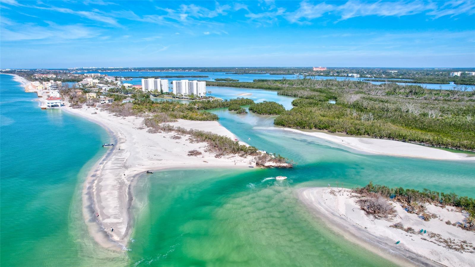 Rarely available–largest floor plan in The Pointe totally renovated with expansive 180-degree water views! Redesigned & remodeled for comfort & convenience, the exquisite finishes & details in this 7th floor coastal home will delight the most discerning buyers! All Impact Glass sliders & windows, porcelain tile throughout, abundant custom millwork & ample storage, a large full-sized laundry room, 2023 HVAC w/UV lights, dual building elevators, private storage area & dedicated under-building parking provides efficiency & comfort. The heart of the home is the chef’s kitchen that was thoughtfully designed with custom wood cabinetry & granite to maximize efficiency, storage & accessibility making entertainment & daily tasks a pleasure. The home flows effortlessly into the large living/dining area wrapped in glass & sunshine beckoning one out onto the expansive lanai with sweeping views of Florida natural vistas & endless intercoastal waterways. Light & bright, morning Sunrise & mainland nightscapes are enhanced with western corner windows unique to this floorplan in addition to the 22’ glassed/screened lanai. Double windows in the kitchen provide mesmerizing views of the sun dancing across the Gulf of Mexico & evening panoramic sunsets! The remodeled electrical plan provides both task & ambient lighting throughout all rooms. The primary Ensuite was redesigned with 2 separate vanities, a walk-in shower & high-end finishes & fixtures. Custom built-ins, including an expansive walk-in closet and a 2nd bedroom & full bath provides luxury accommodations for guests & owners. This 5.3 acre gated, pet-friendly community provides security, privacy & peace of mind with an on-site Property Manager & Maintenance Team for your convenience. Located at the iconic southern tip of Siesta Key, this natural oasis offers a heated lap pool & spa, lighted tennis & pickleball courts, fitness room & saunas, community rooms & sharing library & two picnic/BBQ park-like settings. Boat docks & kayak storage/launces are available at a nominal annual rental fee. Turtle Beach is .4 mile from your door where the free Trolley to Siesta Village gives you worry-free access to Siesta Beach & numerous shops & restaurants. A rare opportunity waits for the savvy buyer who values move-in ready luxury & incomparable natural amenities.
