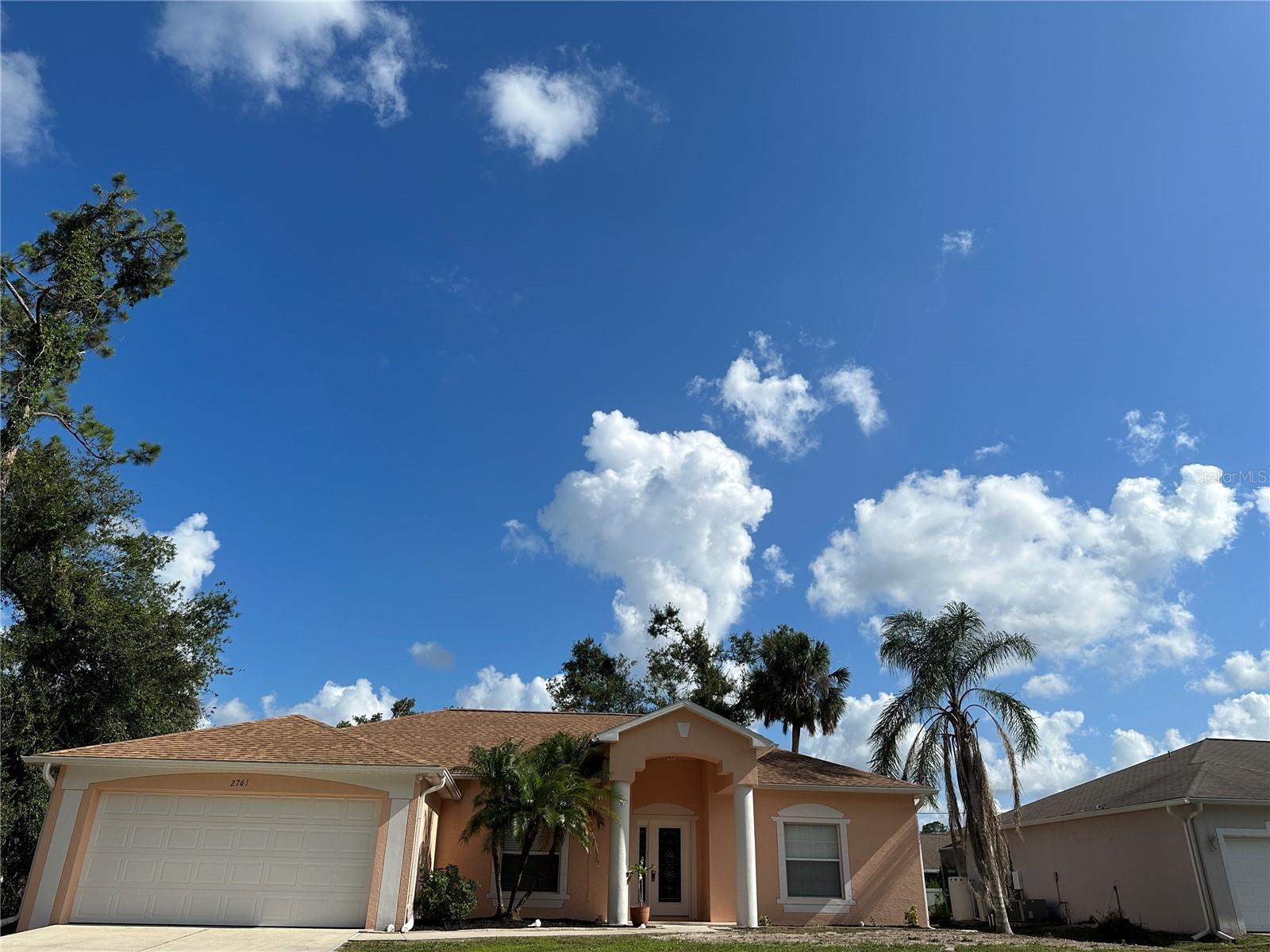 With over 1800 sq ft of living space, the whole family can comfortably spread out. Soaring ceiling heights and tile throughout all living areas creates the feeling of a much larger space. Floor plan features a formal dining area, spacious family room and split bedrooms for maximum privacy. The main suite will easily accommodate King sized furnishings. Walk in closet, garden tub and tiled shower add to the appeal. Eat in kitchen overlooking the family room. Perfect for those you like to entertain. Company will gather at he breakfast bar to chatter away. Plenty of cupboard and pantry space for storage. Slider exit from family room to tiled lanai. Nice place to sip your morning coffee and relish in the privacy. Indoor laundry room and 2 car garage on remote opener. All this and City Water too. Leave that stinky well water behind. All of North Port residents can appreciate the novelty of City water. Conveniently located just off US 41 with great retail and dining options close at hand. North Port is rapidly growing and really a great place to call home.