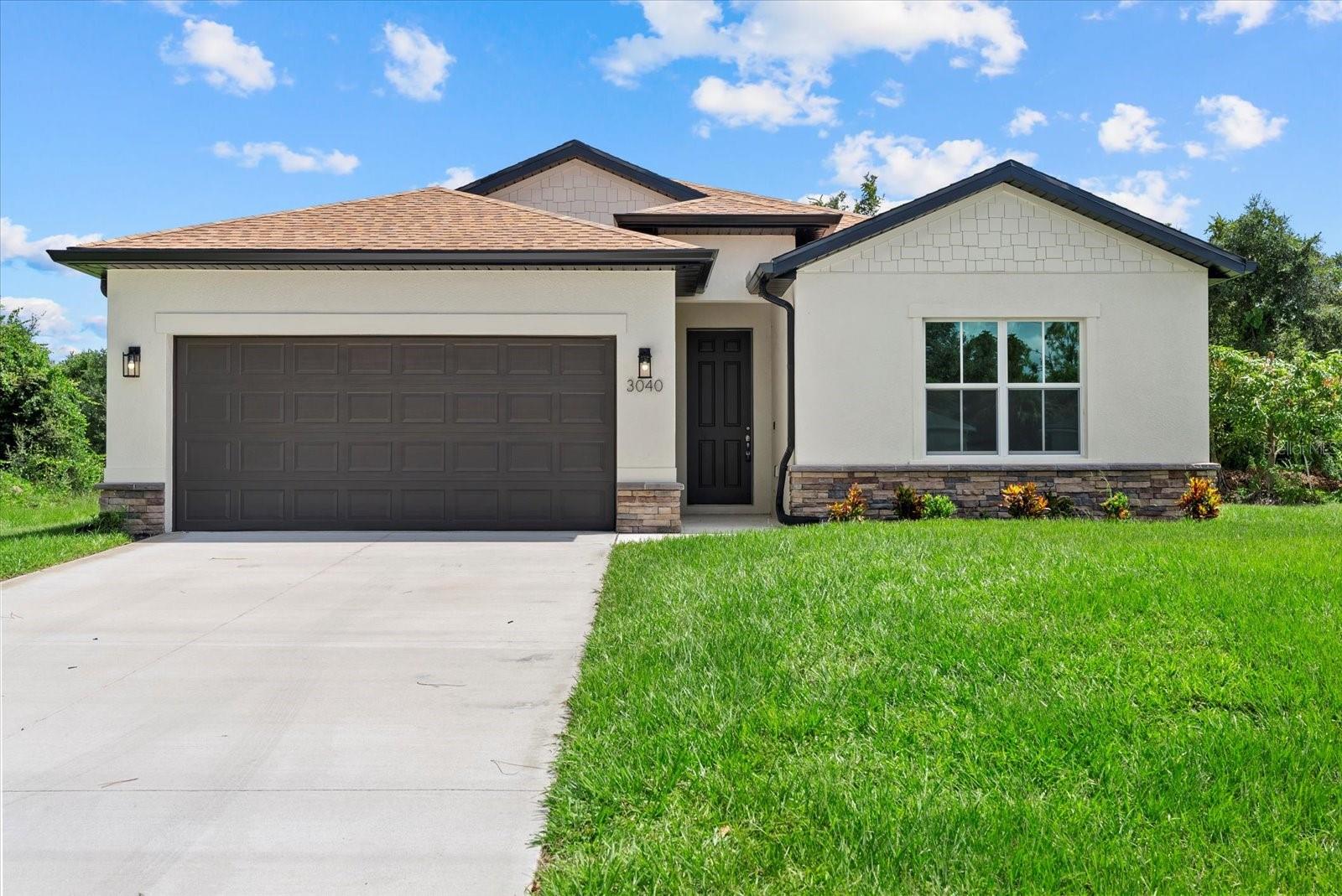 New Construction! Move-in Ready! Seller Concessions avaliable for closing costs or Interest Rate Buy-Down. This beautiful 4-bedroom, 3-bathroom home on a corner lot with a 2-car garage is ready for you to call home. Step inside and be greeted by the spacious great room with soaring 9'4'' ceilings and elegant 8' doors throughout. The modern kitchen INCLUDES a stainless-steel Samsung appliance package, beautiful quartz countertops, and an open layout perfect for entertaining. The Primary bedroom comes complete with a tray ceiling, dual walk-in closets, and a spa-like ensuite with double vanities. The fourth bedroom, located at the front of the house, offers privacy with its own ensuite bathroom, perfect for guests or extended family. This home is packed with high-end finishes, including hurricane-impact windows, tiled showers, stylish and durable flooring, irrigtion system, and a Ring doorbell. Enjoy Florida living year-round on the covered lanai, ideal for outdoor relaxation. Selling concessions are available to make your move even easier! No HOA fees, no CDD. Schedule your showing today!