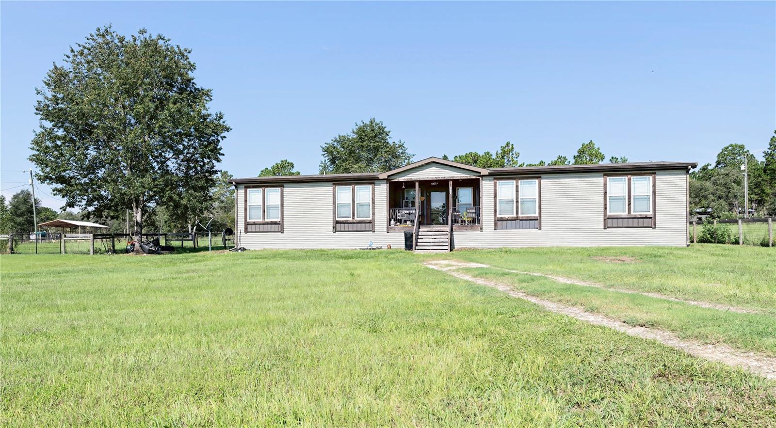 Five Acres of Freedom - Bring Horses, Toys & Dreams! Turnkey 2020-built country homestead on 5 fully fenced acres—modern comfort with true backroad privacy. Like the old Jason Aldean song says, “we’ll be raising hell where the blacktop ends.” This is Country Living Unleashed! Take the 360 interior & exterior tour to see floor plan and layout! Outside there's plenty of room to roam for ATVs, dirt bikes, farming, horses, and livestock. This property is ready for both play and productivity. Inside features include a security alarm, whole-home water filtration, wood burning fireplace and a powerful 4-ton HVAC installed in 2022 for year-round efficiency. This home's location offers fewer cars and more serenity—With no big-city light pollution, the stars put on a nightly show. Seller is motivated—bring your highest & best offers and make this freedom property yours.