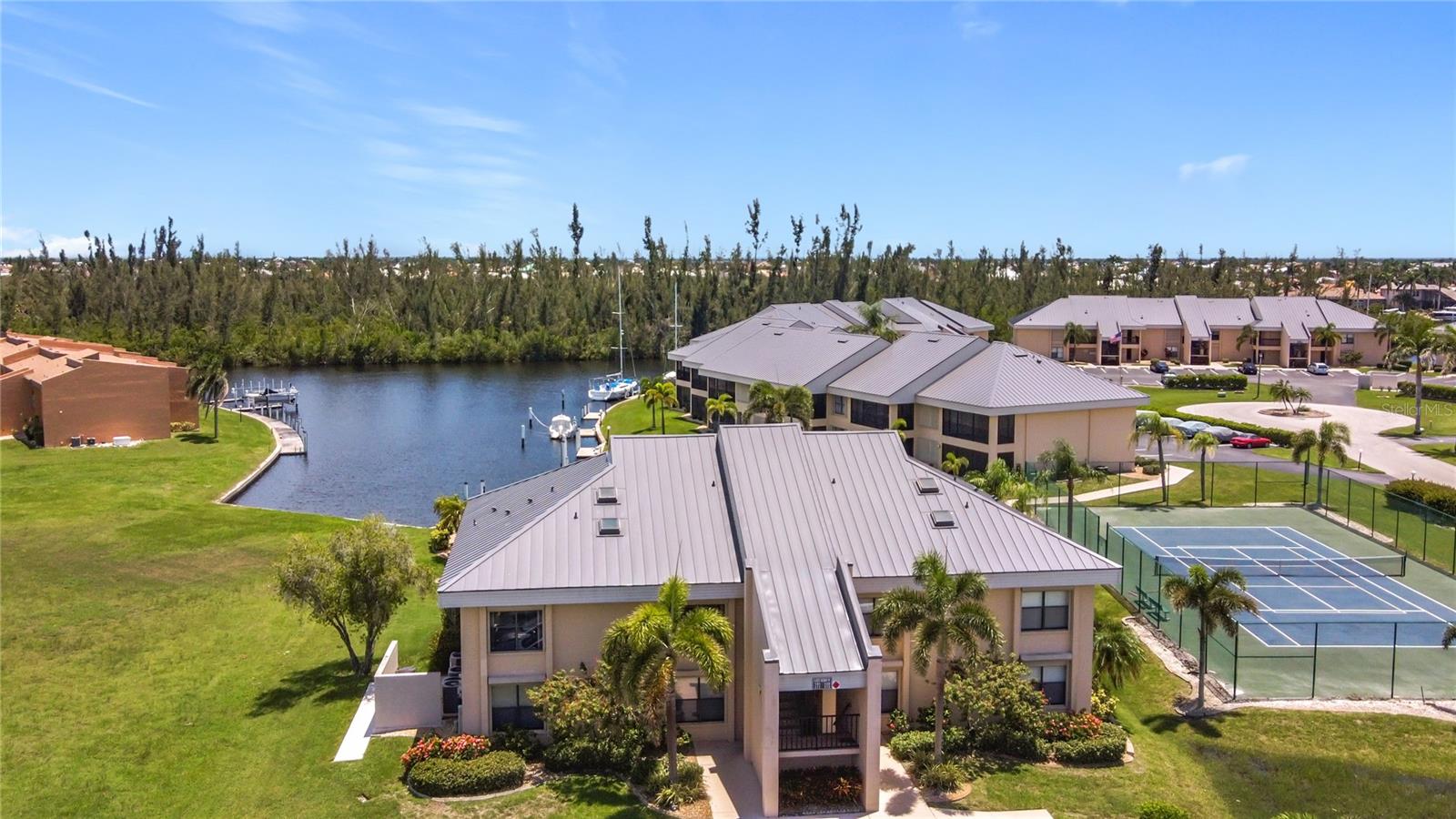 Live a BOATER'S DREAM lifestyle in this meticulously updated, first-floor waterfront condo with dock access just steps from your door - a rare and coveted combination! Every detail has been thoughtfully modernized, and this home comes FULLY furnished and stocked with everything from linens to dishes - just bring your suitcase and settle right in to effortless coastal luxury living! Designed with both comfort and long-term protection in mind, this impressive property also features HURRICANE PROTECTION FOR YOUR PEACE OF MIND & A BRAND NEW METAL ROOF! NO PREVIOUS STORM DAMAGE.
This immaculate, TURNKEY 3-bedroom, 2-bath residence offers a bright and open concept featuring gleaming tile floors throughout, designer lighting, and a stylish contemporary kitchen with sleek quartz countertops, stainless steel appliances, custom cabinetry and an expansive island - perfect for everyday family gatherings or entertaining guests. The spacious living area flows into a screened-in lanai with delightful views of the canal, dock, pool and tennis/pickle ball courts—perfect for relaxing and enjoying a sunset after a leisurely day on the water. Walk just a few steps from your back door to the docks, offering seamless access (no bridges!) to the Gulf through picturesque PGI canals - ideal for boaters, kayakers, and water lovers alike.
The primary suite features a custom walk-in closet, spa-like ensuite bath, and private sliders leading to the lanai. Two guest bedrooms, an additional full bath (both bathrooms have heated towel bars!) and a spacious interior laundry room complete the home offering a seamless blend of luxury, comfort, and everyday convenience.
This move-in-ready condo combines modern convenience, premium upgrades, and unmatched waterfront access, making it perfect as a primary home, luxurious seasonal escape or investment property.
NO STAIRS, NO UPDATES NEEDED - just TURN THE KEY and start living your Florida waterfront dream!
Tucked away in the peaceful, well-kept waterfront community of VENETIAN ISLES, offering a newly-renovated waterfront pool, tennis and pickle ball courts on beautifully maintained grounds—all supported by LOW, well-managed HOA fees with NO special assessments! Enjoy the added convenience of AVAILABLE BOAT SLIPS (No wait list!) for boating enthusiasts with sailboat access.
Conveniently located in the heart of Punta Gorda Isles near the quaint, historic downtown Punta Gorda with weekly farmer's markets, festivals, waterfront dining including the vast array of fantastic local restaurants in and around Fisherman's Village Waterfront Mall!