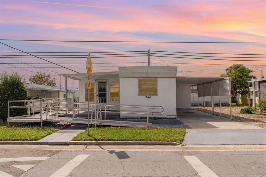 Offers 1% lender credit at closing. Everything goes with this charming mobile home — just move right in! This well-maintained home features a new roof and durable laminate flooring throughout. Designed with accessibility in mind, it includes a wheelchair ramp and is wheelchair accessible for added convenience.

Located just steps away from the clubhouse, laundry facilities, and shuffleboard courts, this home offers both comfort and community. Enjoy a low monthly HOA fee of only $130, which covers water, sewer, access to the clubhouse, tennis courts, and a sparkling pool. The on-site laundry is open daily from 6:00 AM to 10:00 PM, making everyday living easy.

Pets are welcome — bring your dogs and cats! With everything included and so many amenities nearby, this is an ideal opportunity for affordable, easy living in a friendly neighborhood.