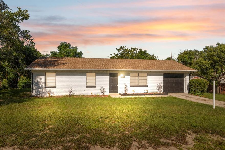 One or more photo(s) has been virtually staged. Situated in a quiet Brooksville neighborhood, this charming 3-bedroom, 2-bath home with a 1-car garage offers a perfect mix of comfort, style, and functionality. The white painted brick exterior is complemented by a matching dark gray front door and garage, giving the home a clean, cohesive look. A concrete driveway and walkway lead to the entry, where three large front-facing windows fill the interior with natural light. Inside, the spacious living room features warm-toned vinyl flooring and flows into a dining area that opens to a recently updated kitchen. Thoughtfully designed for both everyday use and entertaining, the kitchen boasts white shaker cabinets, granite countertops, a white subway tile backsplash, stainless steel appliances, and a large window above the sink that brightens the entire space. Sliding glass doors off the dining area lead to a bright family room surrounded by windows, ideal for relaxing, hosting, or creating a home office or play area. To the left side of the home, the primary bedroom offers a walk-in closet and a private bath with a walk-in tiled shower and modern vanity. Two additional bedrooms also include walk-in closets and carpeted floors. A second full bath features a tub/shower combo with beige tile. Outside, a covered back porch overlooks the spacious backyard with mature trees, partial fencing, and open lawn—perfect for outdoor gatherings or simply enjoying the peaceful setting. The home sits on a flat lot and is just 9 miles from the Suncoast Expressway (SR-589), providing quick access to Tampa and surrounding areas for commuters. Only 12 miles away, Weeki Wachee Springs State Park offers crystal-clear springs and kayaking adventures, while Pine Island Beach, located 17 miles away, is perfect for sunsets and coastal relaxation. Nearby shopping and dining options at Coastal Landing and Towne Square Mall are just minutes away, making this home an ideal blend of convenience and peaceful living.