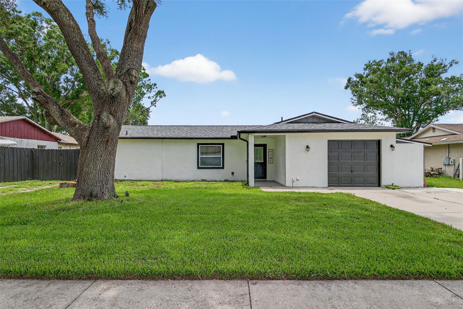Charming Home in Highly Desired LUTZ! No HOA or CDD! Welcome to this wonderful 3 Bedroom 2 Bath Home on a spacious .028 acre full fenced Lot, perfect for outdoor living, play, pets and gatherings. Enjoy peaceful evenings under the paved pergola. This generously sized Home has a great split Floor plan featuring both a Living Room & Family Room complete with a cozy wood-burning fireplace-perfect for Holiday nights. Perfect layout for ENTERTAINING. This Home has had major upgrades in the last few years; HVAC-2024 Roof-2021 Water Heater-2018 Gutters-2023 Luxury Vinyl flooring-2023 and both Bathrooms recently updated. The open layout offers comfort and flexibility, and the location is unbeatable. Ideally located to EVERYTHING you need from Shopping, Dining, Schools and more. Don't miss out! Homes in this area go fast so call TODAY to schedule your private Showing!!