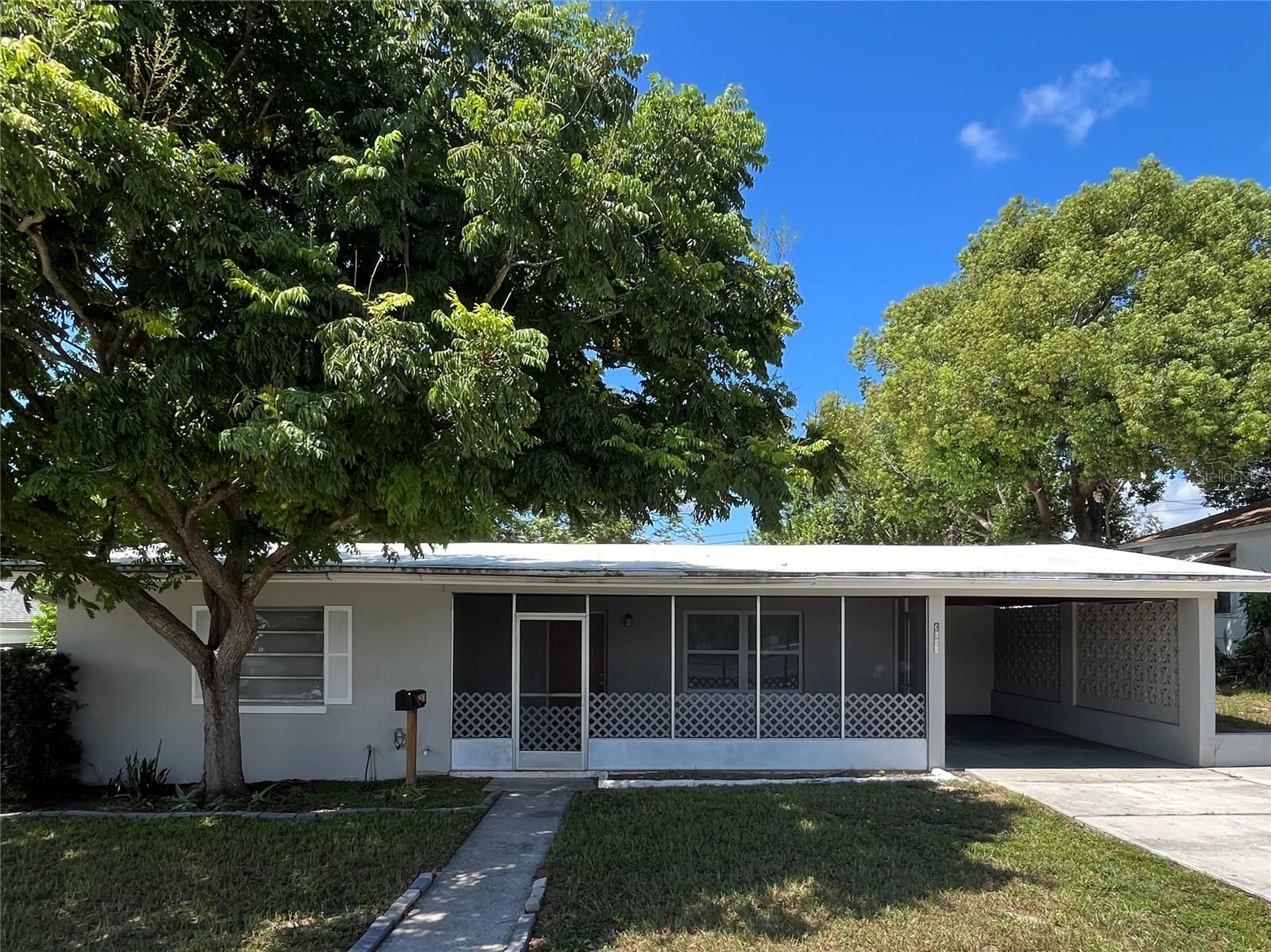 This spacious 4-bedroom home features a covered carport for easy parking, a screened-in porch perfect for enjoying Florida breezes, and a private backyard ideal for relaxing or entertaining. Centrally located in downtown New Port Richey, you'll be just steps from parks, local shops, and vibrant community activities—offering both comfort and convenience in one inviting package